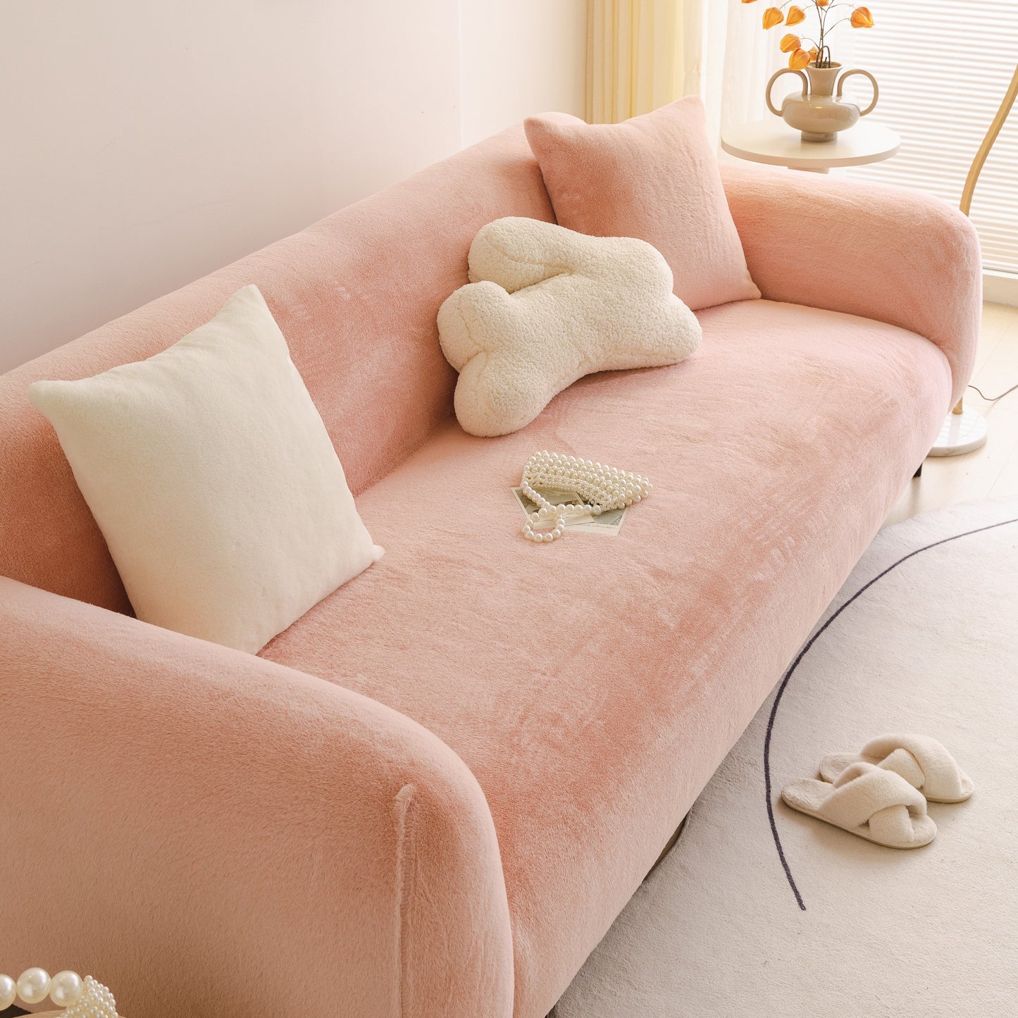 Soft Plush Warm Sofa Cover Stretchable Cozy Velvet Couch Protector for Fall & Winter on a pink velvet sofa with pillows.