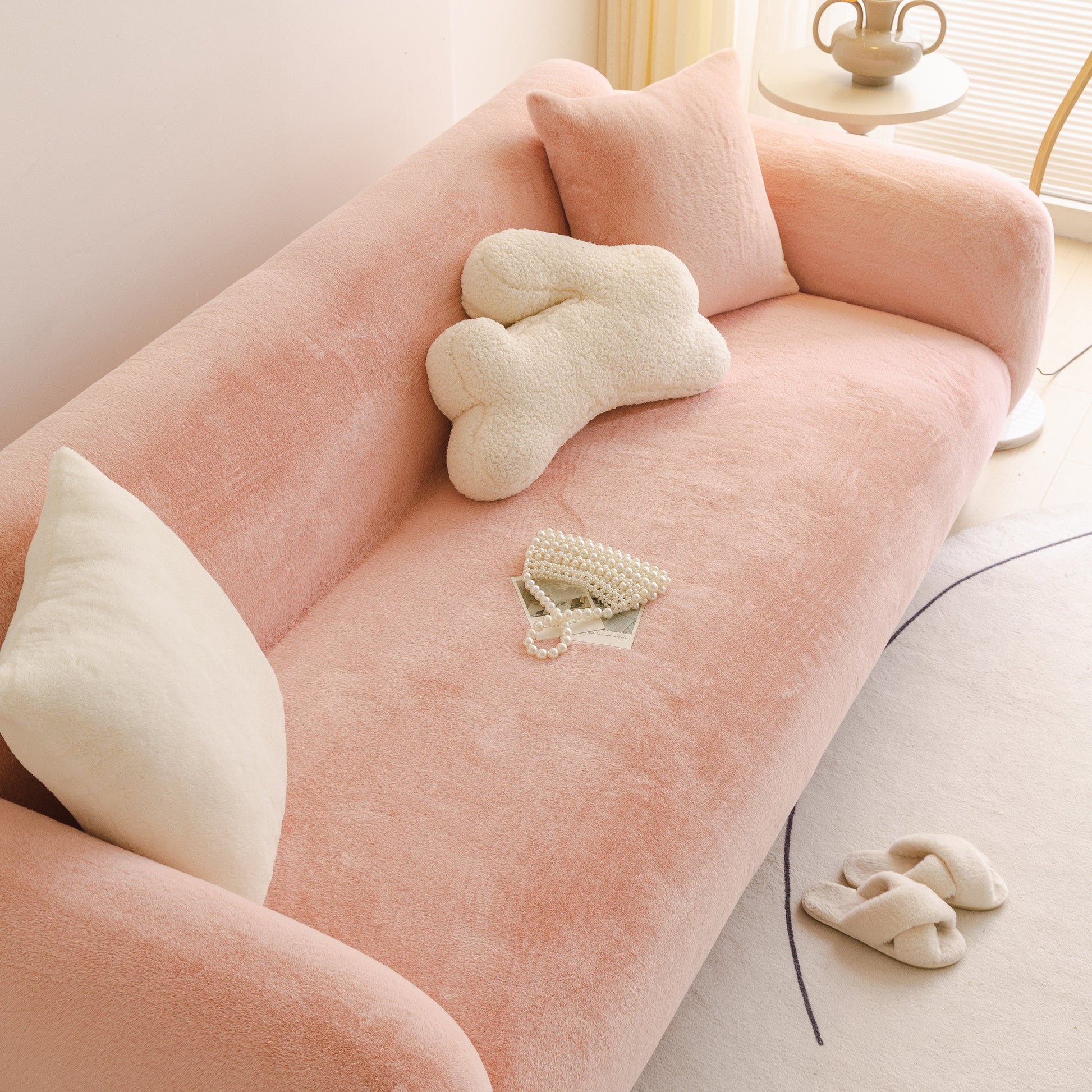 Soft Plush Warm Sofa Cover Stretchable Cozy Velvet Couch Protector for Fall & Winter on a pink couch with decorative pillows