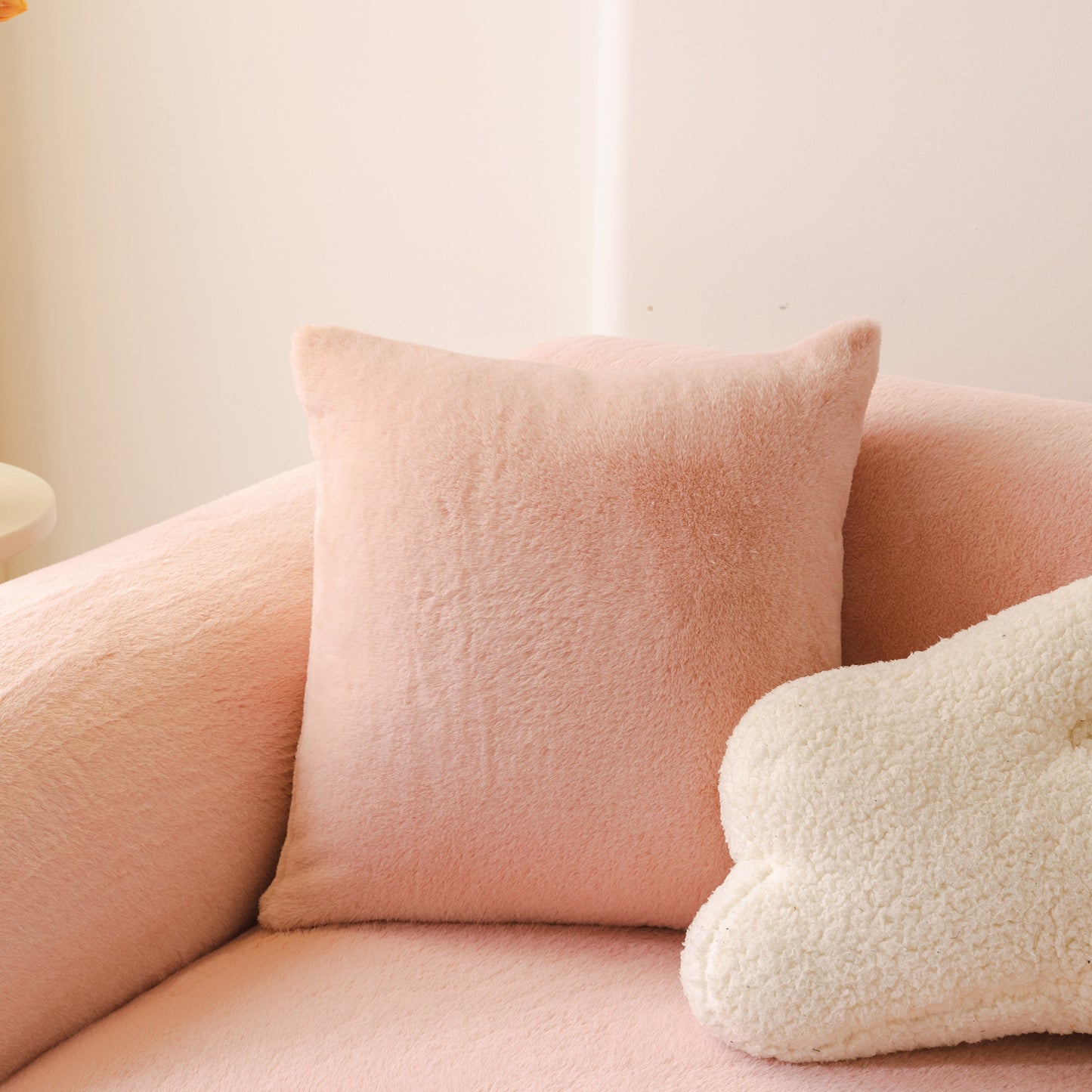 Soft Plush Warm Sofa Cover Stretchable Cozy Velvet Couch Protector for Fall & Winter on a pink sofa with a fluffy pillow