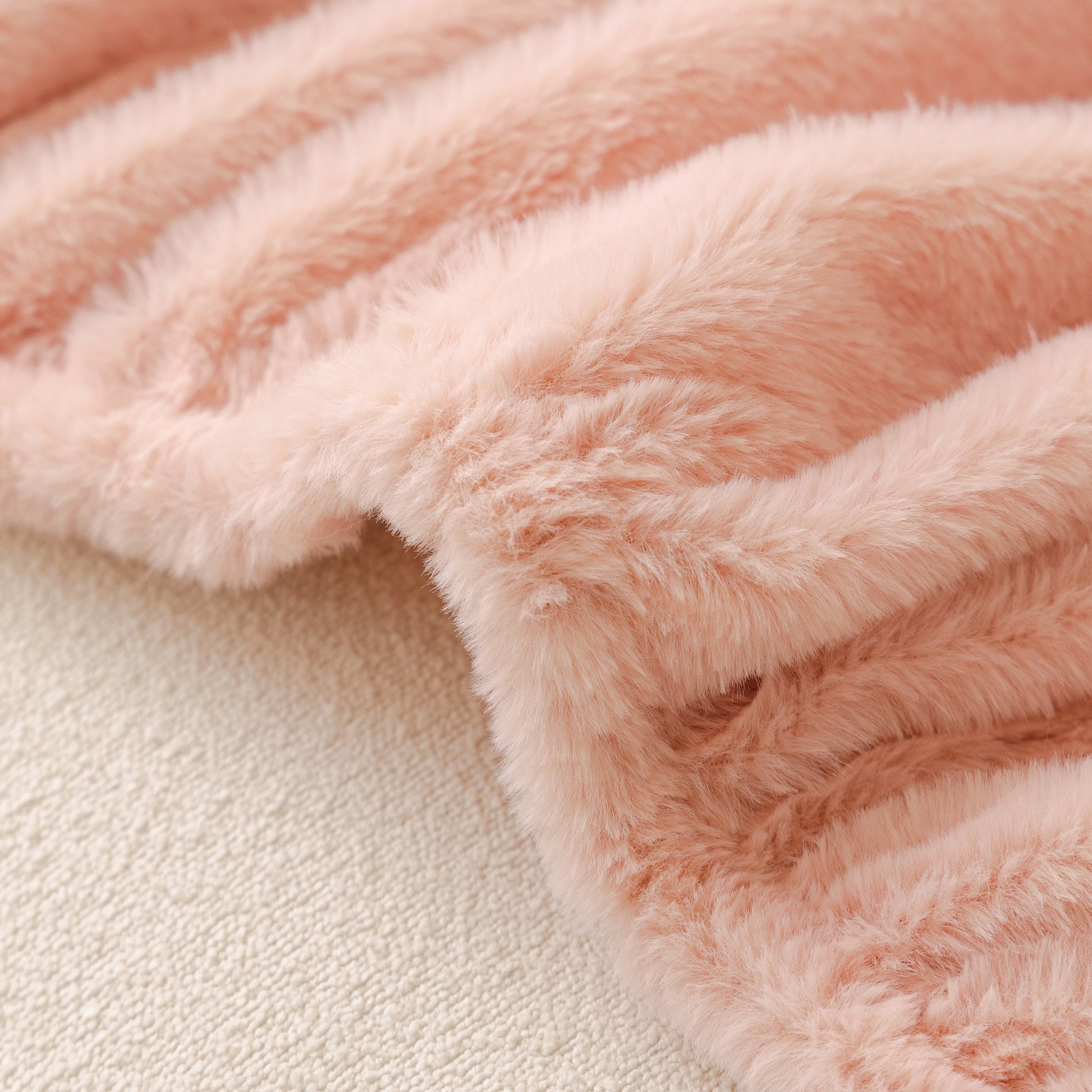 Close-up of Soft Plush Warm Sofa Cover Stretchable Cozy Velvet Couch Protector for Fall & Winter in luxurious pink velvet fabric.
