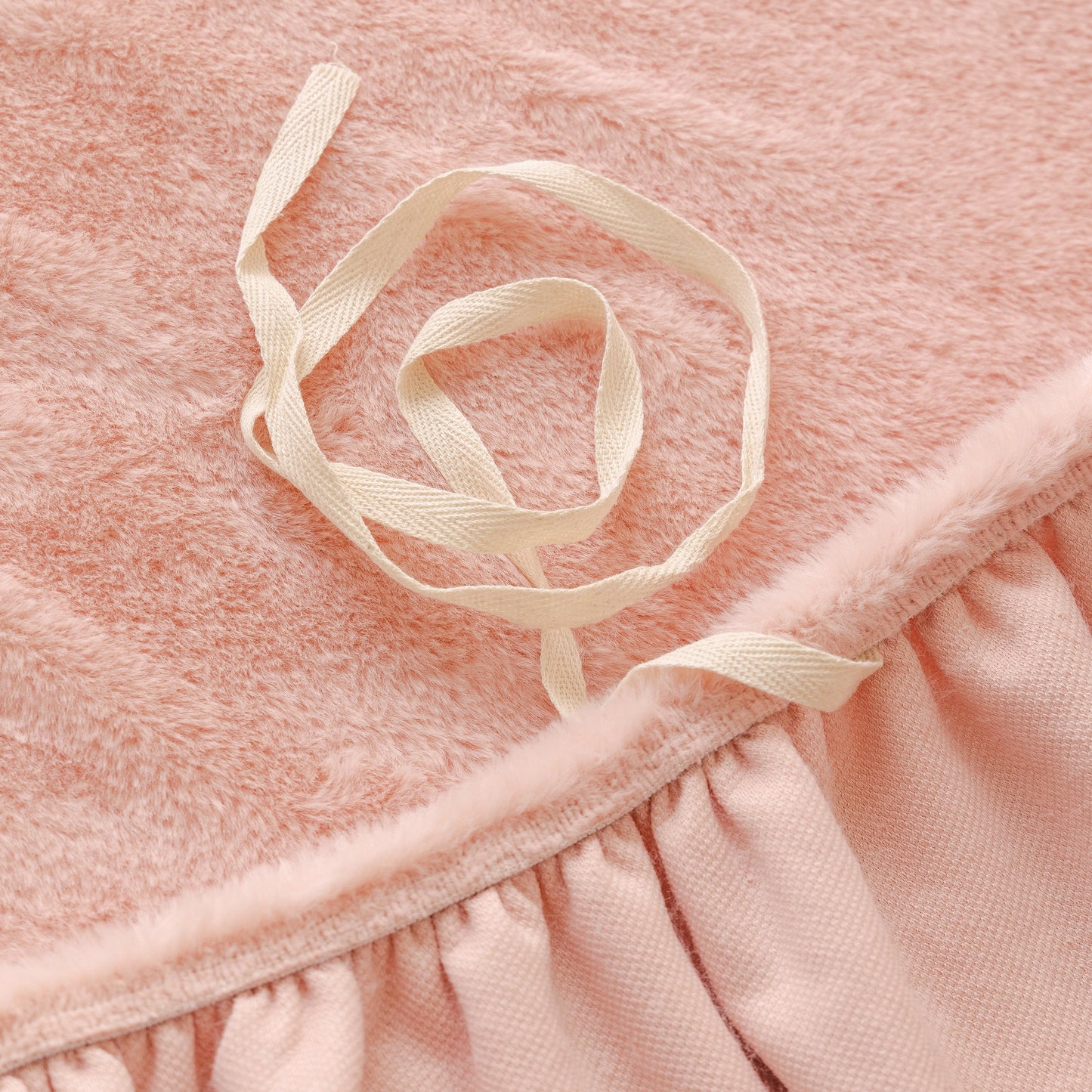 Close-up of the Soft Plush Warm Sofa Cover Stretchable Cozy Velvet Couch Protector for Fall & Winter in pink with ribbon detail.