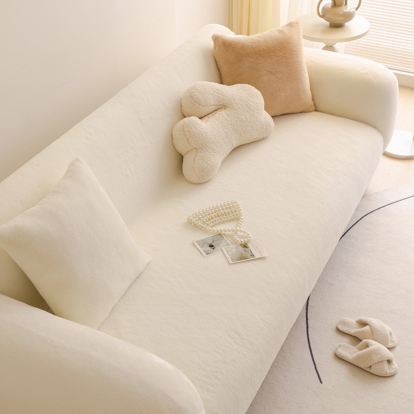 Soft Plush Warm Sofa Cover Stretchable Cozy Velvet Couch Protector for Fall & Winter on a cream-colored sofa with decorative pillows.