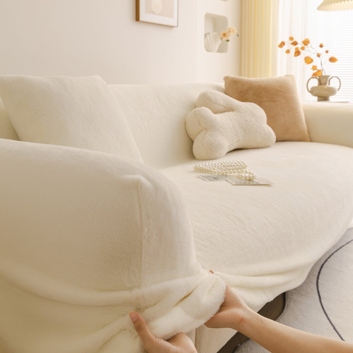 Soft Plush Warm Sofa Cover Stretchable Cozy Velvet Couch Protector for Fall & Winter draping over cream sofa with pillows.