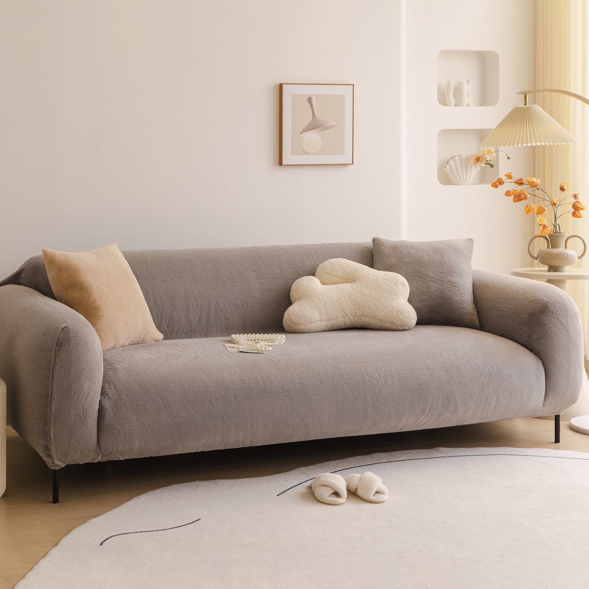 Modern living room with Soft Plush Warm Sofa Cover Stretchable Cozy Velvet Couch Protector for Fall & Winter on grey sofa.