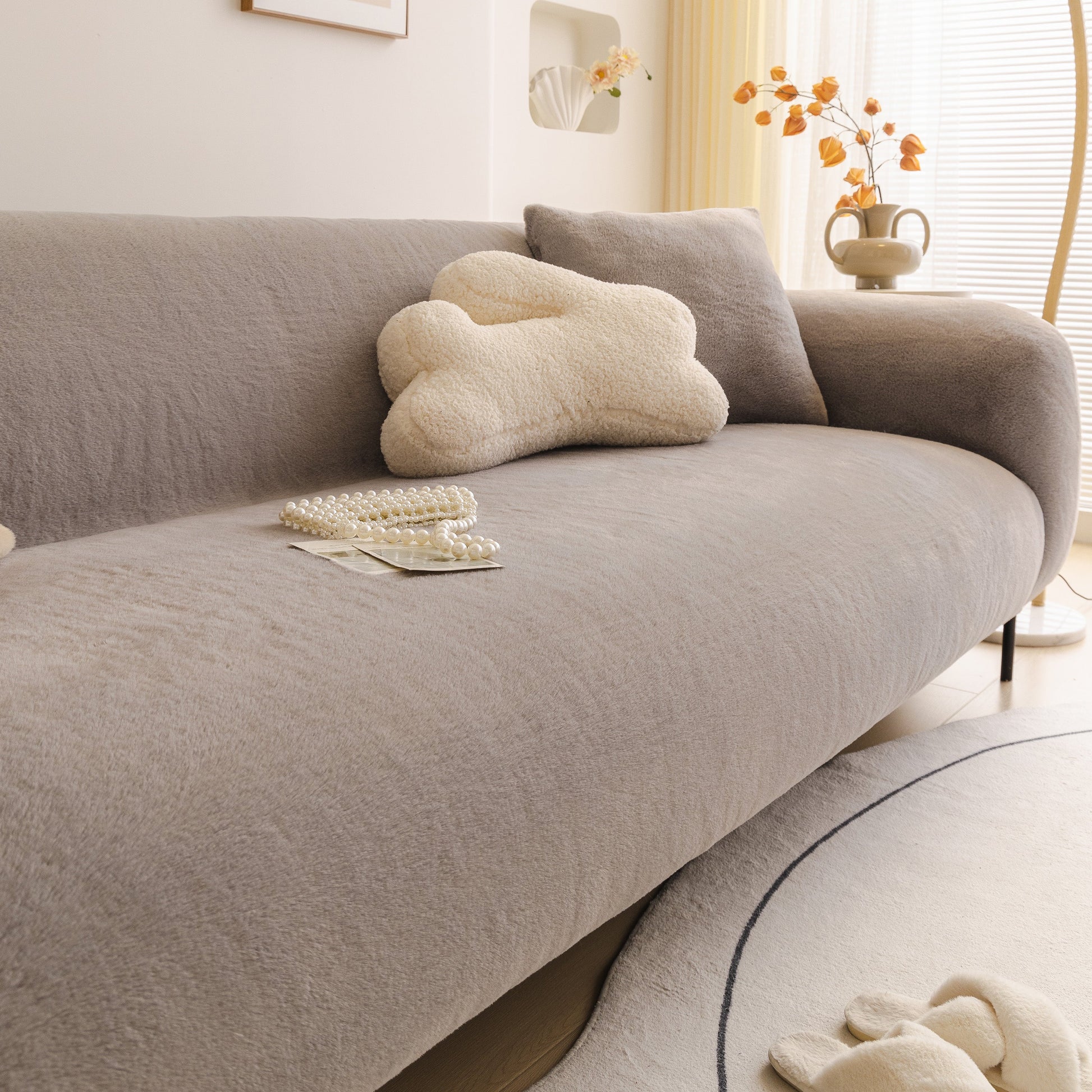 Soft Plush Warm Sofa Cover Stretchable Cozy Velvet Couch Protector for Fall & Winter on a modern grey sofa with decor pillows