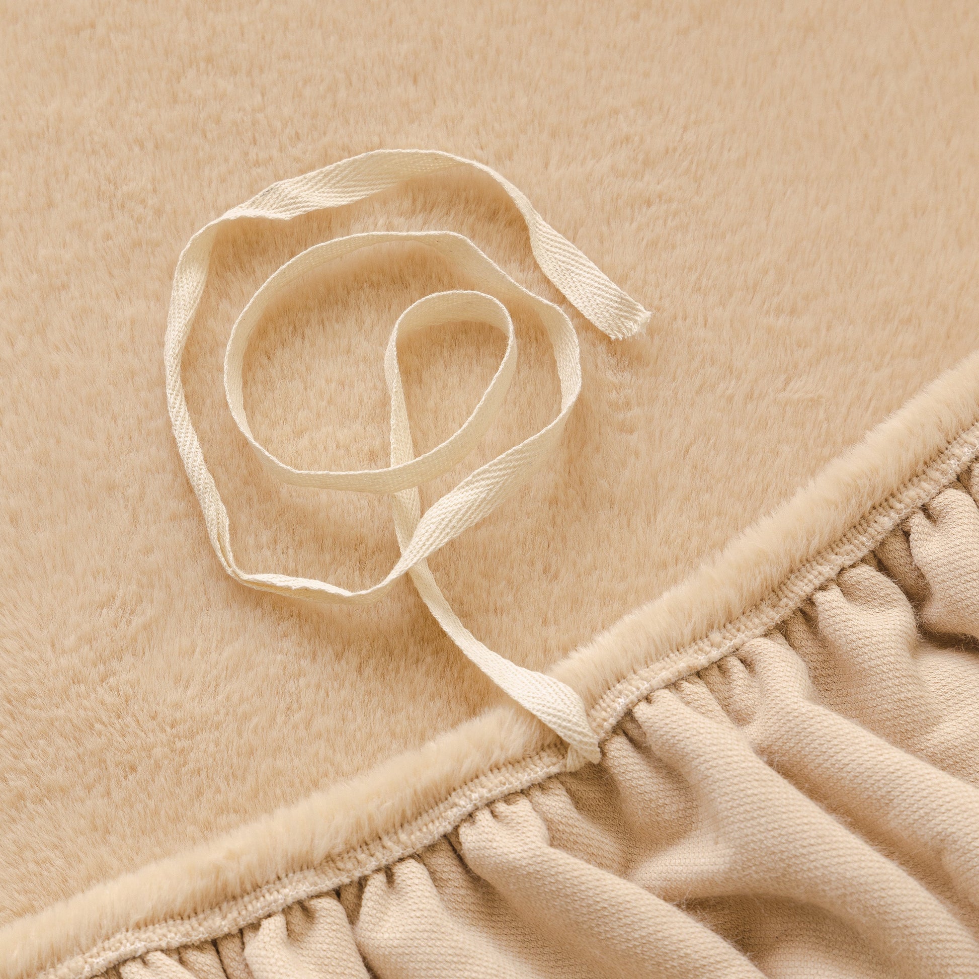 Close-up of Soft Plush Warm Sofa Cover Stretchable Cozy Velvet Couch Protector for Fall & Winter with elastic edge detail.