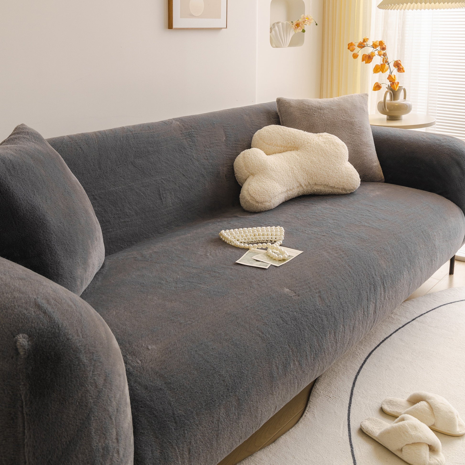 Soft Plush Warm Sofa Cover Stretchable Cozy Velvet Couch Protector for Fall & Winter on a grey sofa in a cozy living room.
