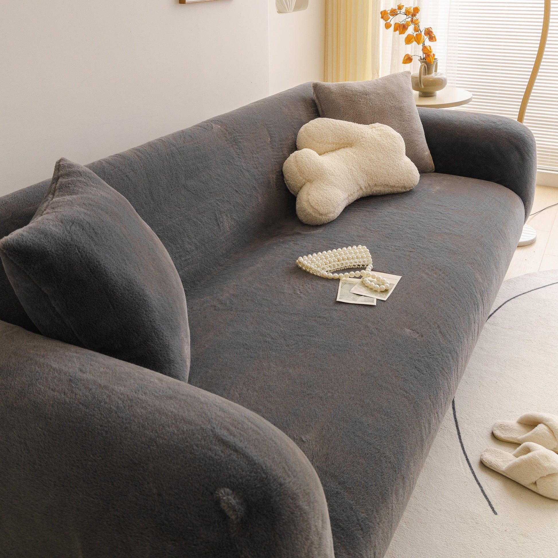 Soft Plush Warm Sofa Cover Stretchable Cozy Velvet Couch Protector for Fall & Winter on a modern sofa with decorative pillow.
