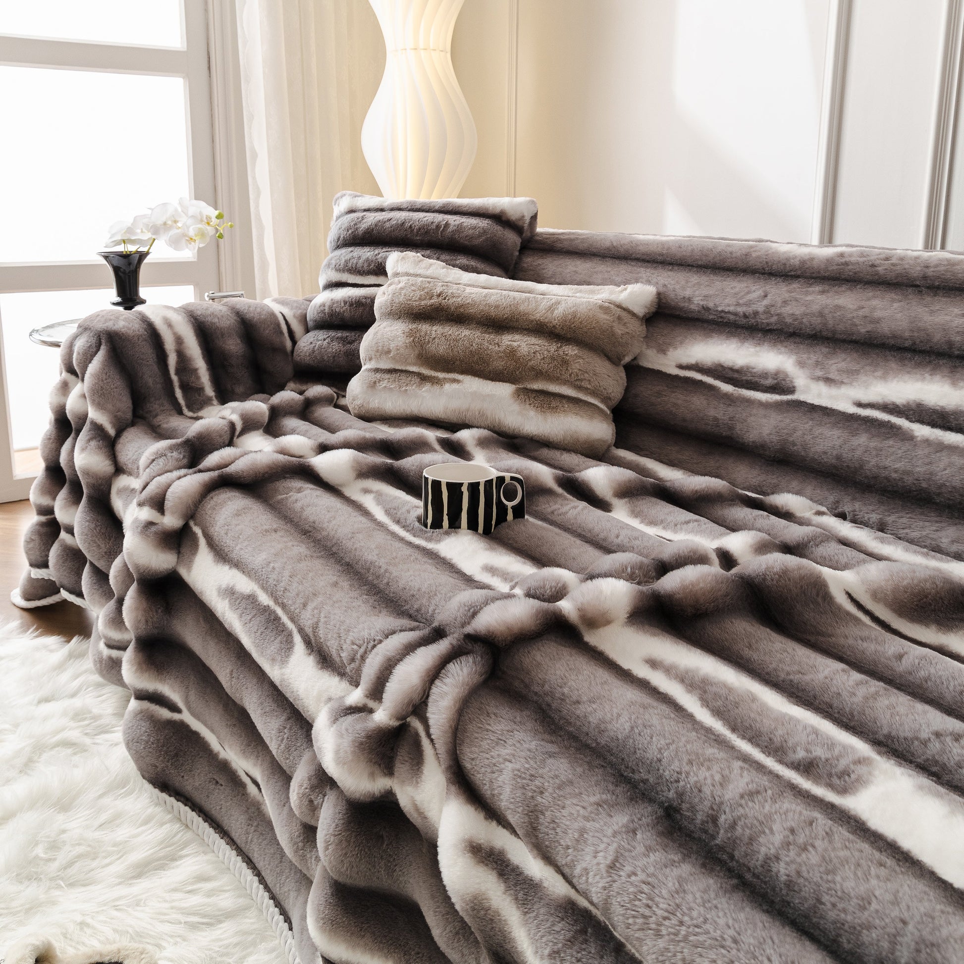 Luxurious living room with Ultra Soft Faux Fur Couch Cover – Large, Fluffy, and Elegant Sofa Throw Blanket draped on a modern sofa.