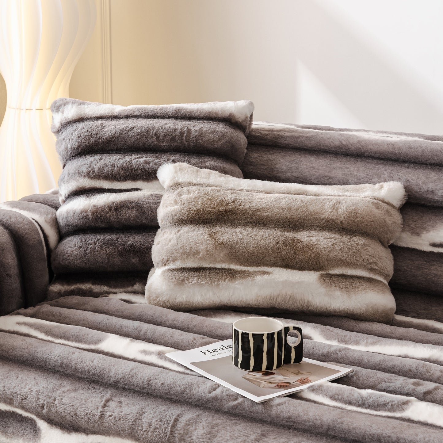 Ultra Soft Faux Fur Couch Cover – Large, Fluffy, and Elegant Sofa Throw Blanket displayed on a sofa with stylish pillows and a mug.