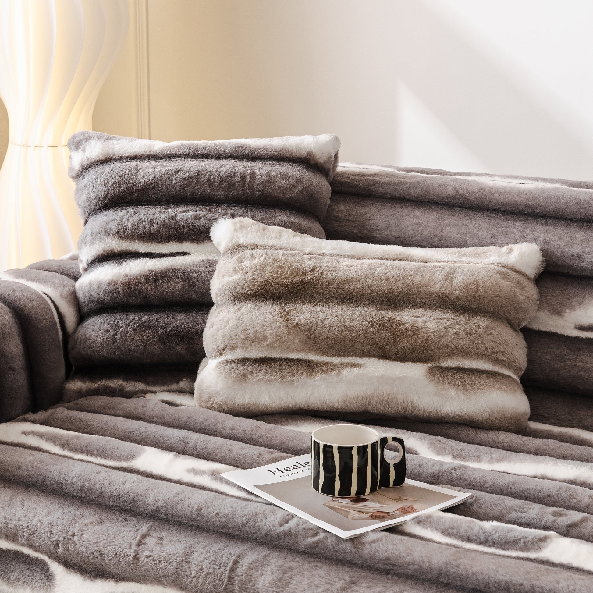 Ultra Soft Faux Fur Couch Cover – Large, Fluffy, and Elegant Sofa Throw Blanket displayed on a sofa with stylish pillows and a mug.