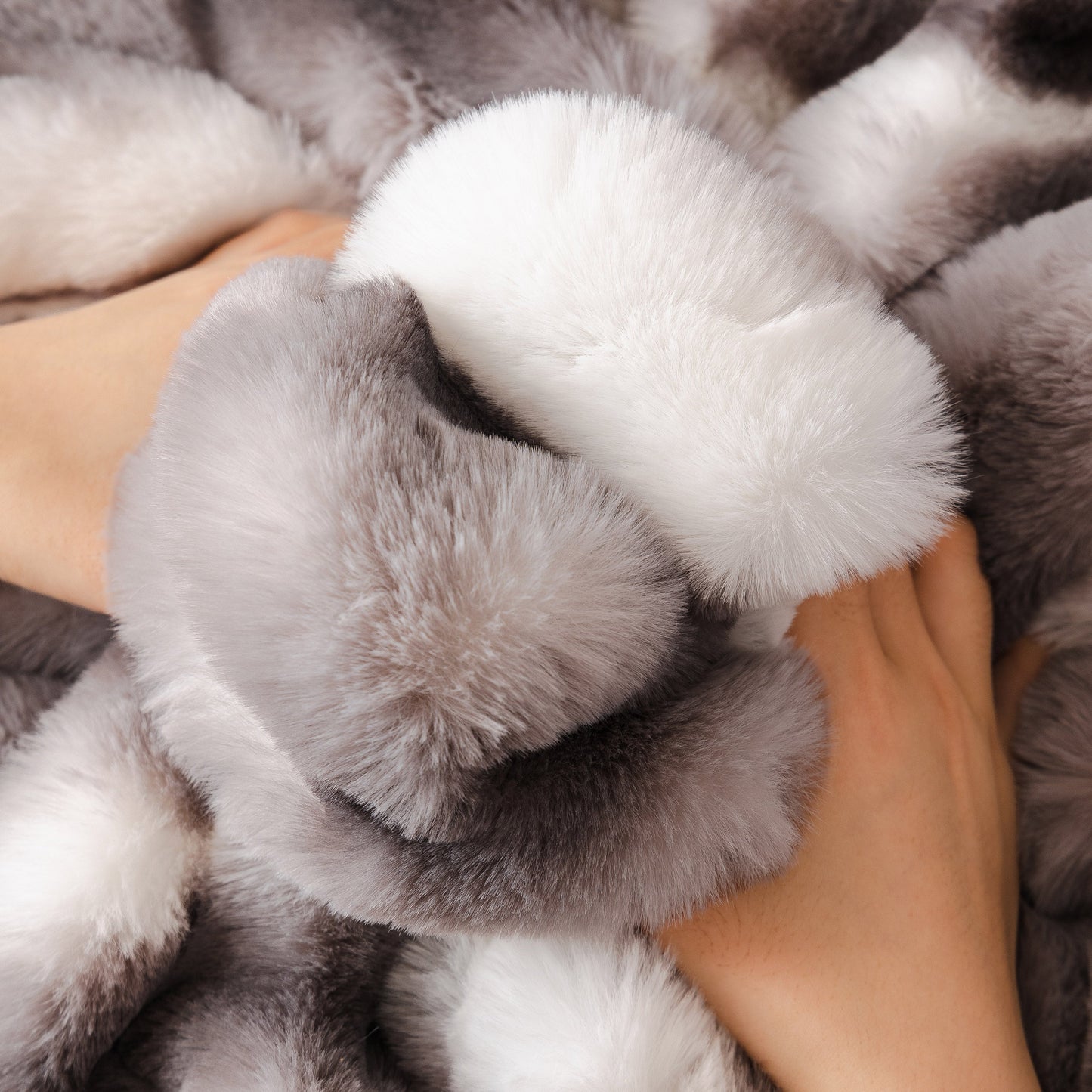 Hands touching Ultra Soft Faux Fur Couch Cover – Large, Fluffy, and Elegant Sofa Throw Blanket showcasing plush texture.