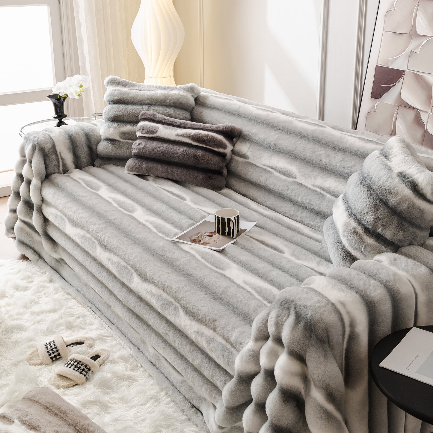 Ultra Soft Faux Fur Couch Cover – Large, Fluffy, and Elegant Sofa Throw Blanket on a modern gray couch with pillows and magazines