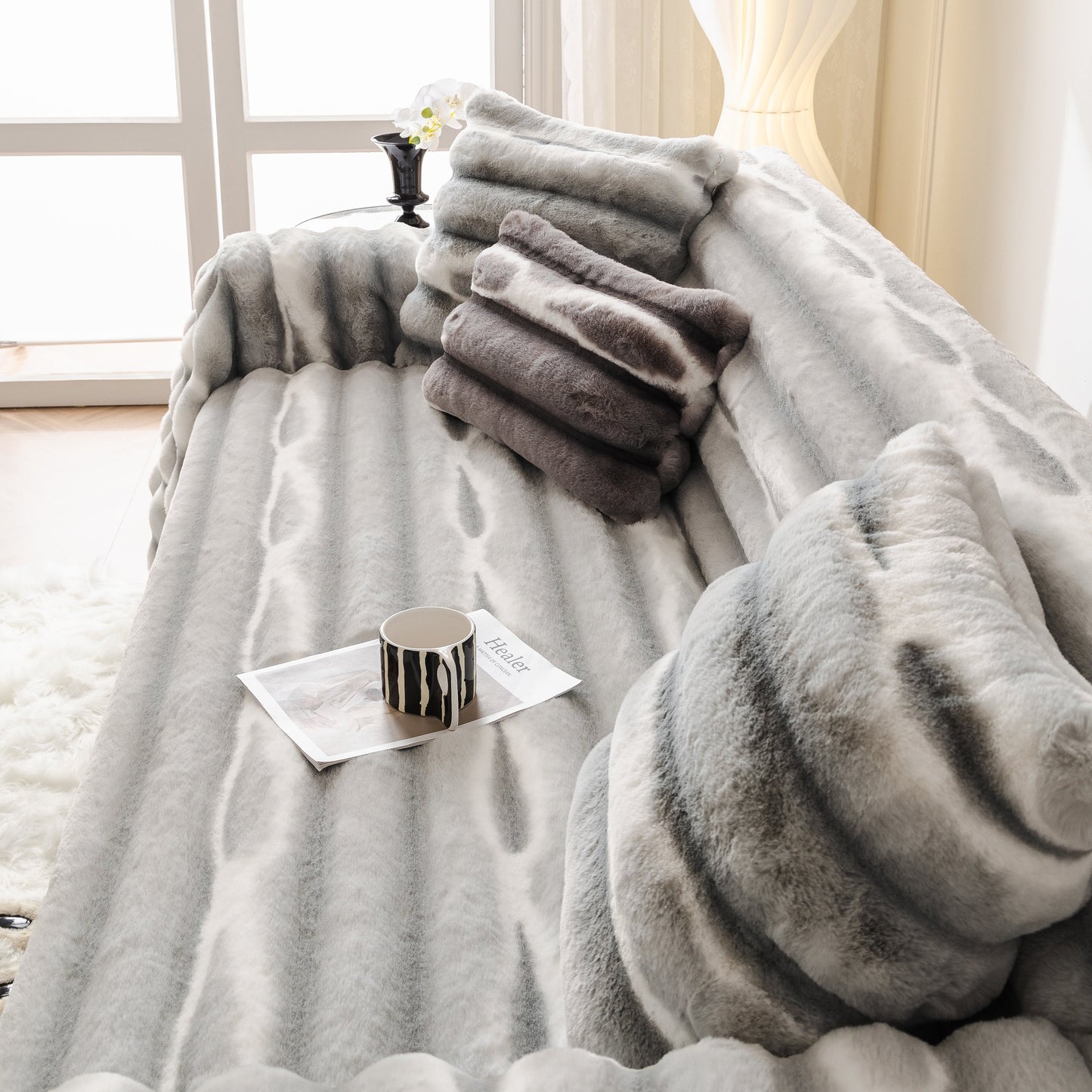 Ultra Soft Faux Fur Couch Cover – Large, Fluffy, and Elegant Sofa Throw Blanket on a stylish sofa with pillows and a coffee cup.