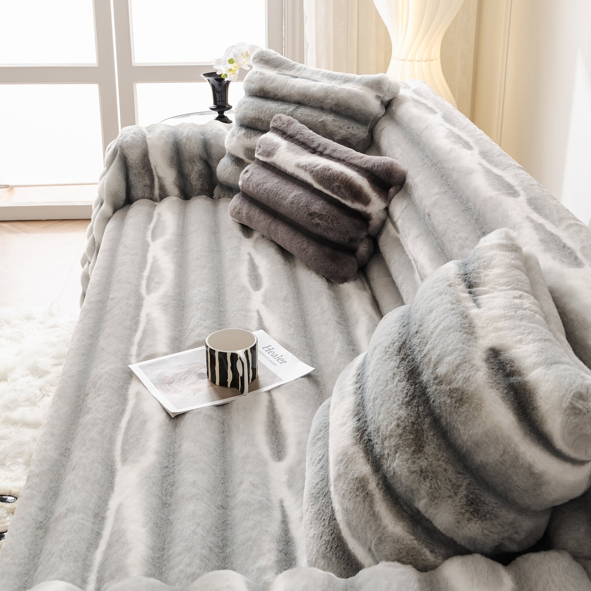 Ultra Soft Faux Fur Couch Cover – Large, Fluffy, and Elegant Sofa Throw Blanket on a stylish sofa with pillows and a coffee cup.