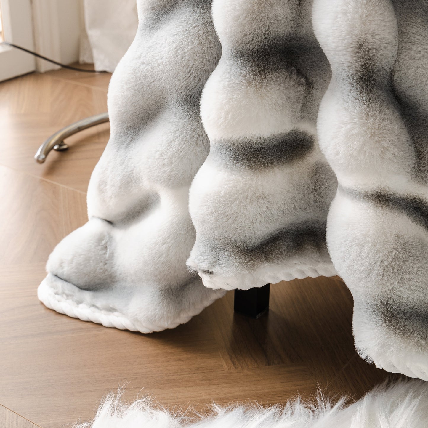 Ultra Soft Faux Fur Couch Cover – Large, Fluffy, and Elegant Sofa Throw Blanket in gradient pattern on wooden floor.