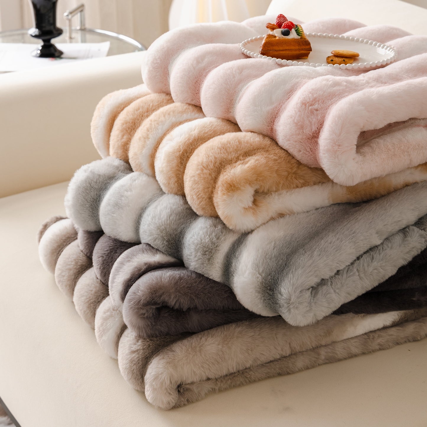 Stack of Ultra Soft Faux Fur Couch Cover – Large, Fluffy, and Elegant Sofa Throw Blanket in various colors on a couch.