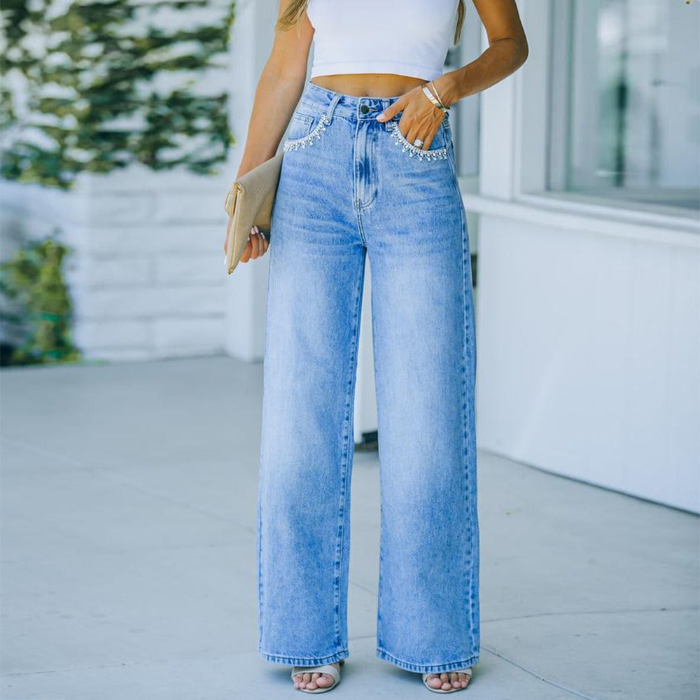 Model wearing "Ava" Petal Pocket Wide-Leg Denim Jeans in light blue, showcasing chic design and comfort.