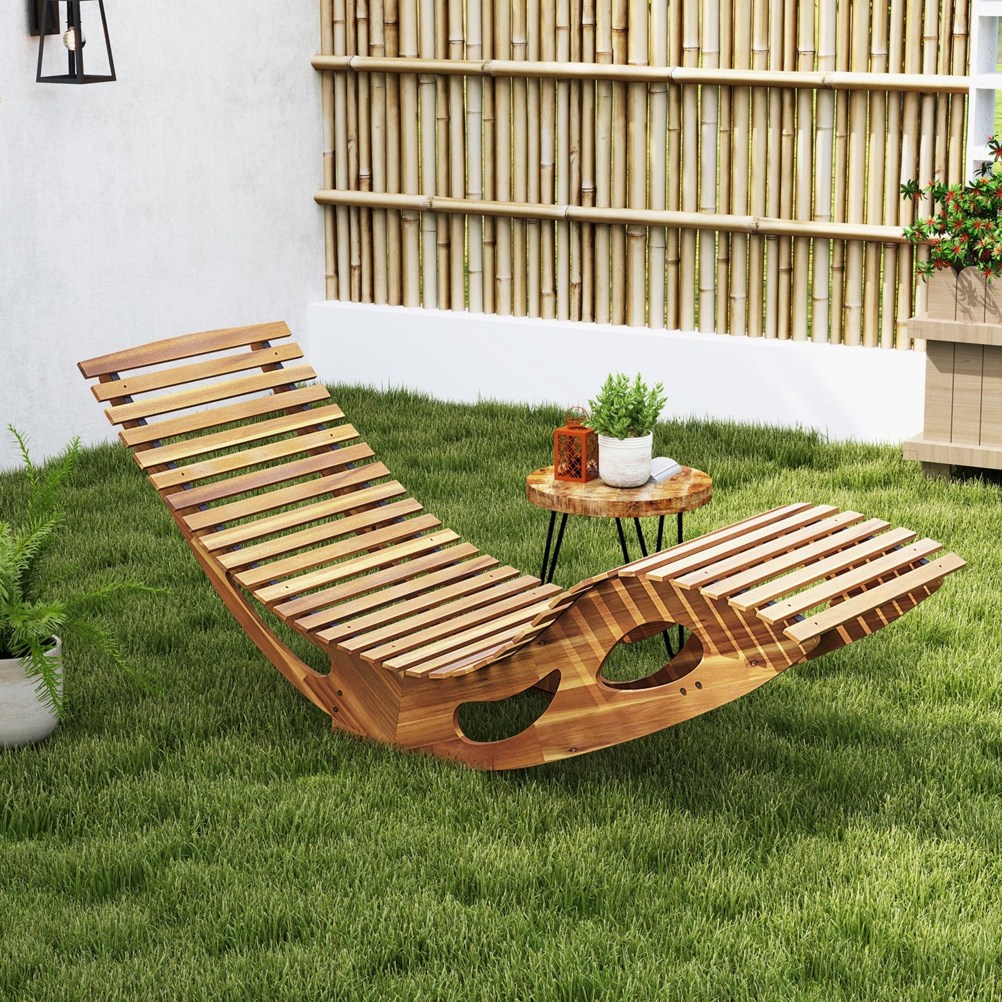 Acacia Wood Patio Rocking Sun Lounger Chaise Lounge with Ergonomic Curved Seat on grass with bamboo backdrop.