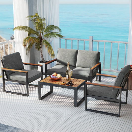 4 Piece Patio Aluminum Furniture Set with Armrests and Tabletop-Gray on a sunny balcony overlooking the sea