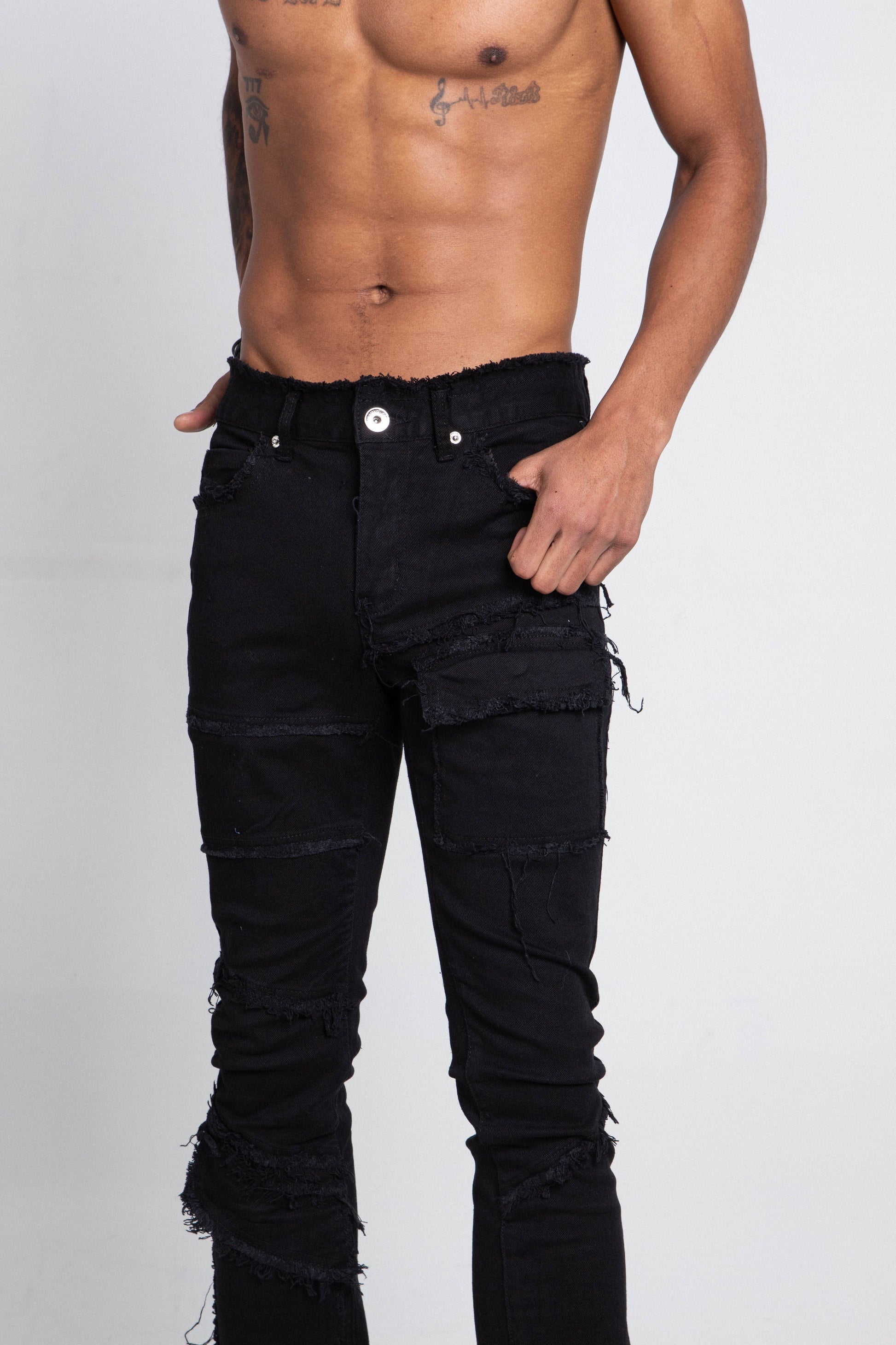 AS405 BLACK DISTRESSED STACKED JEANS with purple lace print and grey wash, five-pocket design, mid-rise stretchy fit on male model.