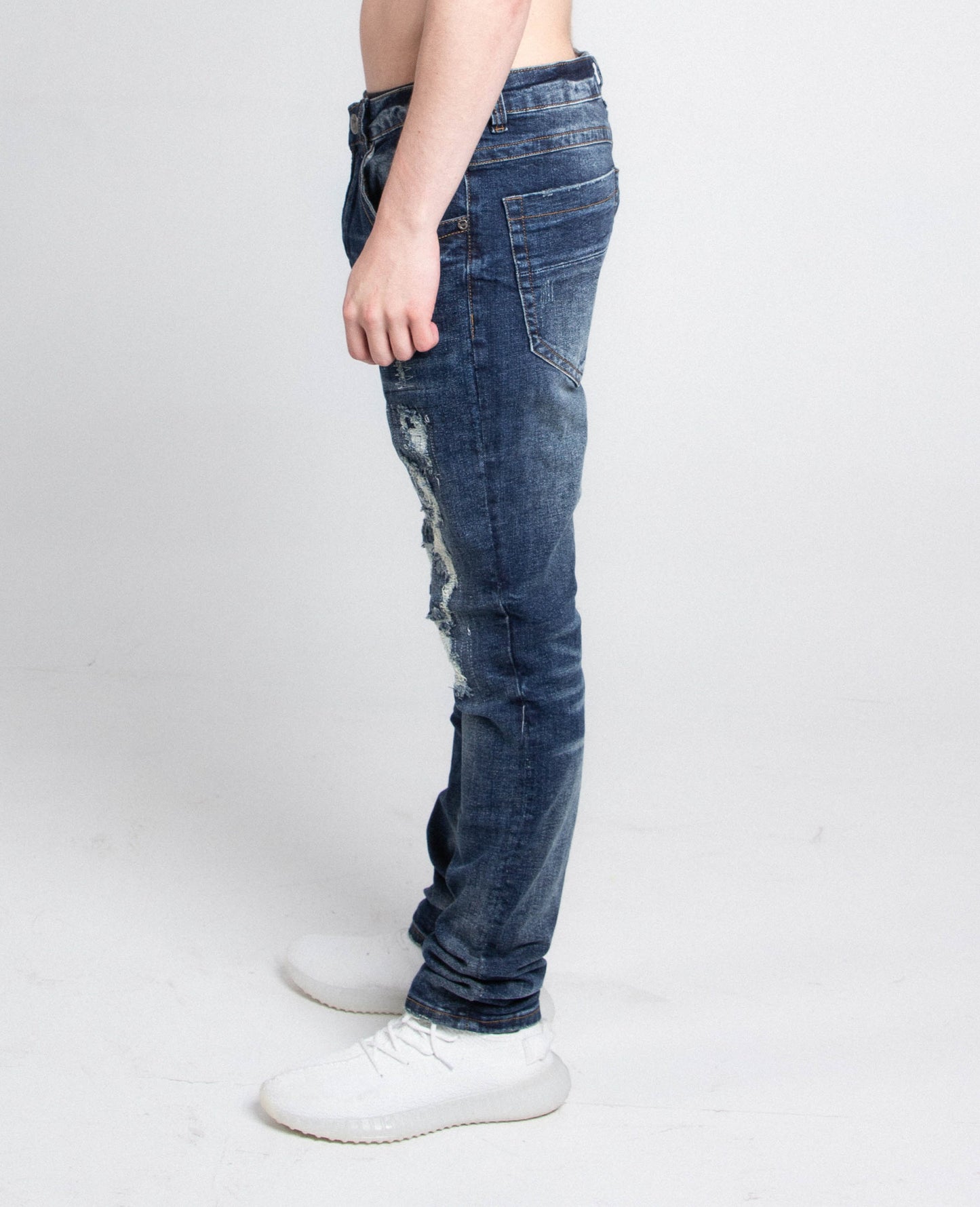 Side view of A403 SMALL RIPPED MID-RISE SKINNY JEANS showing ripped detail and mid-rise fit.