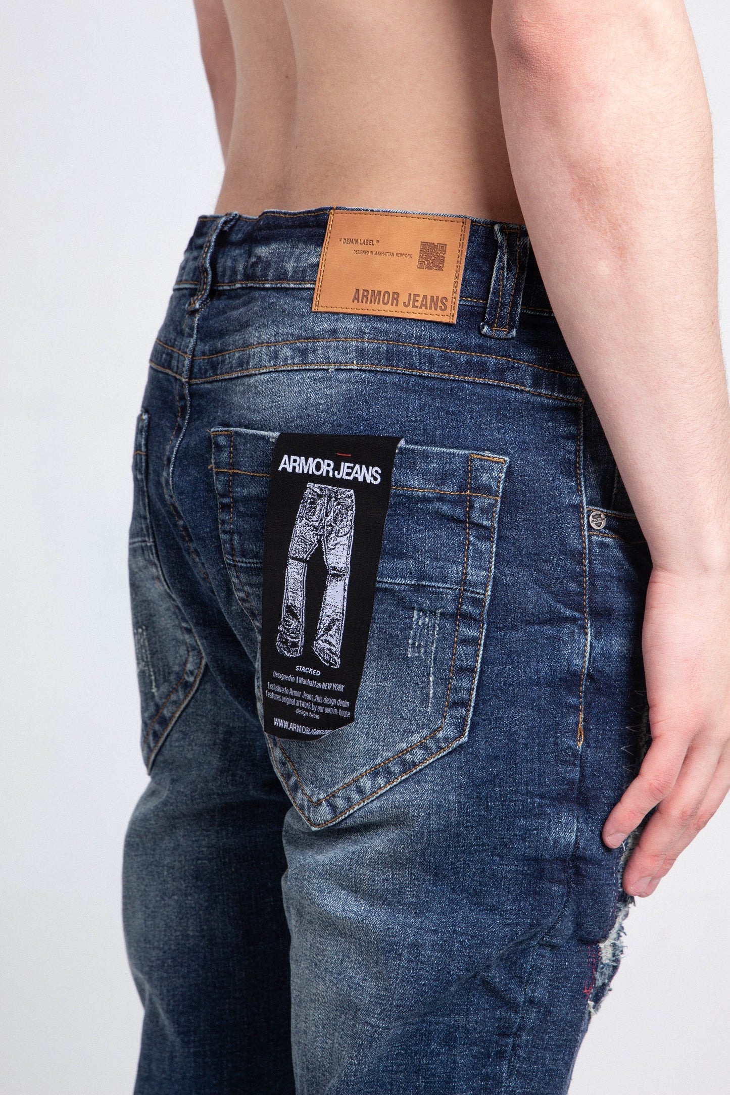 Back view of A403 SMALL RIPPED MID-RISE SKINNY JEANS showcasing ripped design, belt loops, and Armor Jeans branding.
