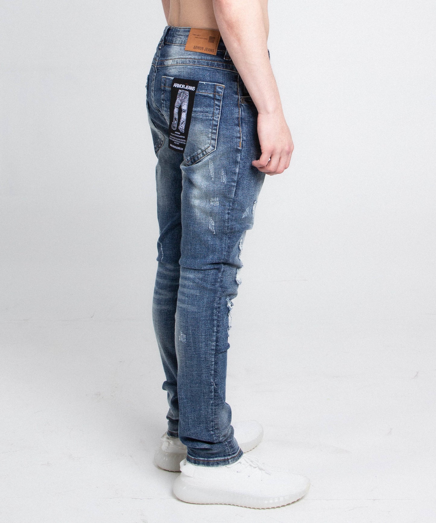 Side view of A406 CASUAL DISTRESSED SKINNY JEANS with stretchy fabric, mid rise waist, belt loops, and five pockets design.