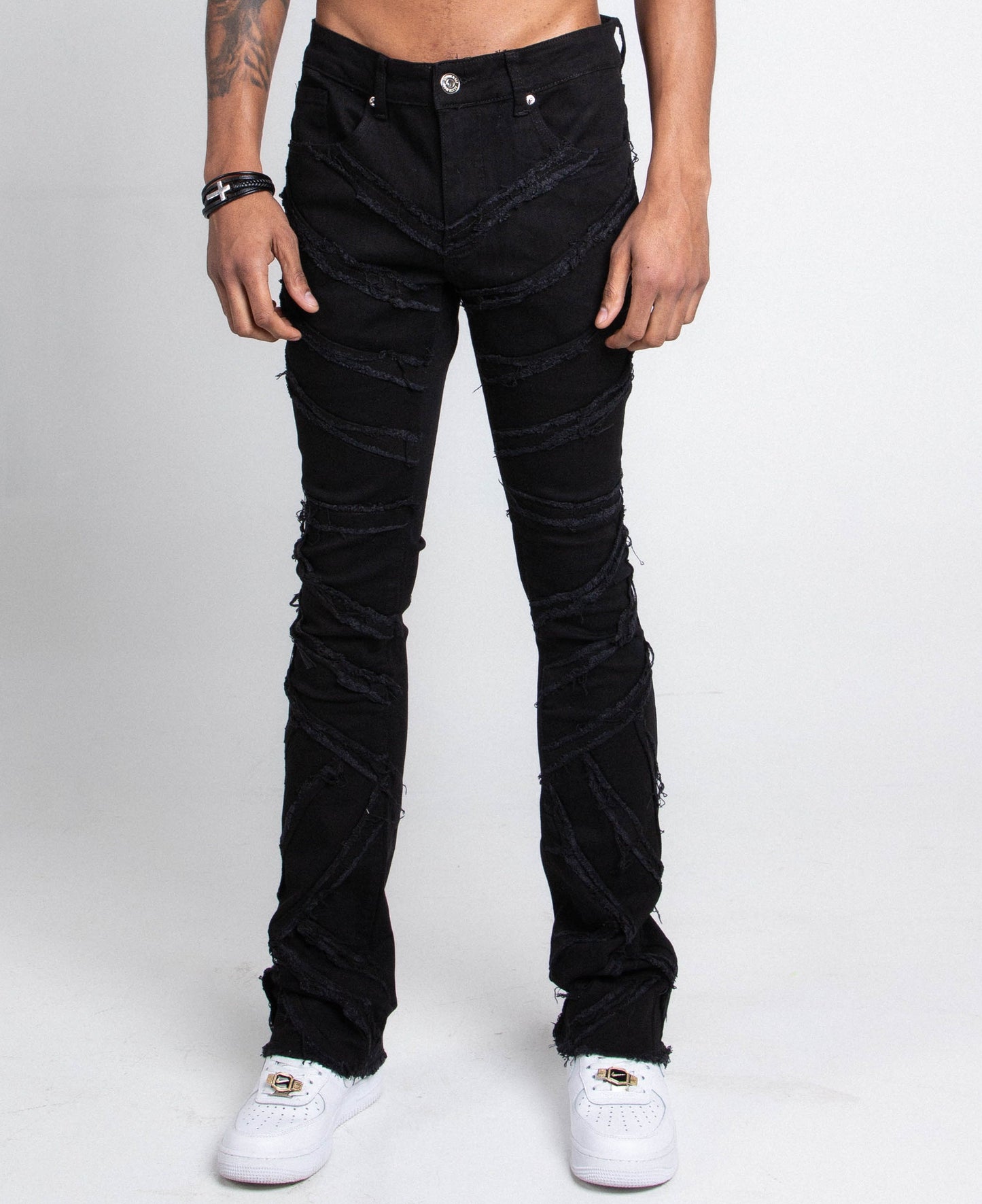 AJS410 SHREDDED STACKED JEANS featuring a mid rise, stretchy fabric, shredded stacked legs, and a five-pocket design.