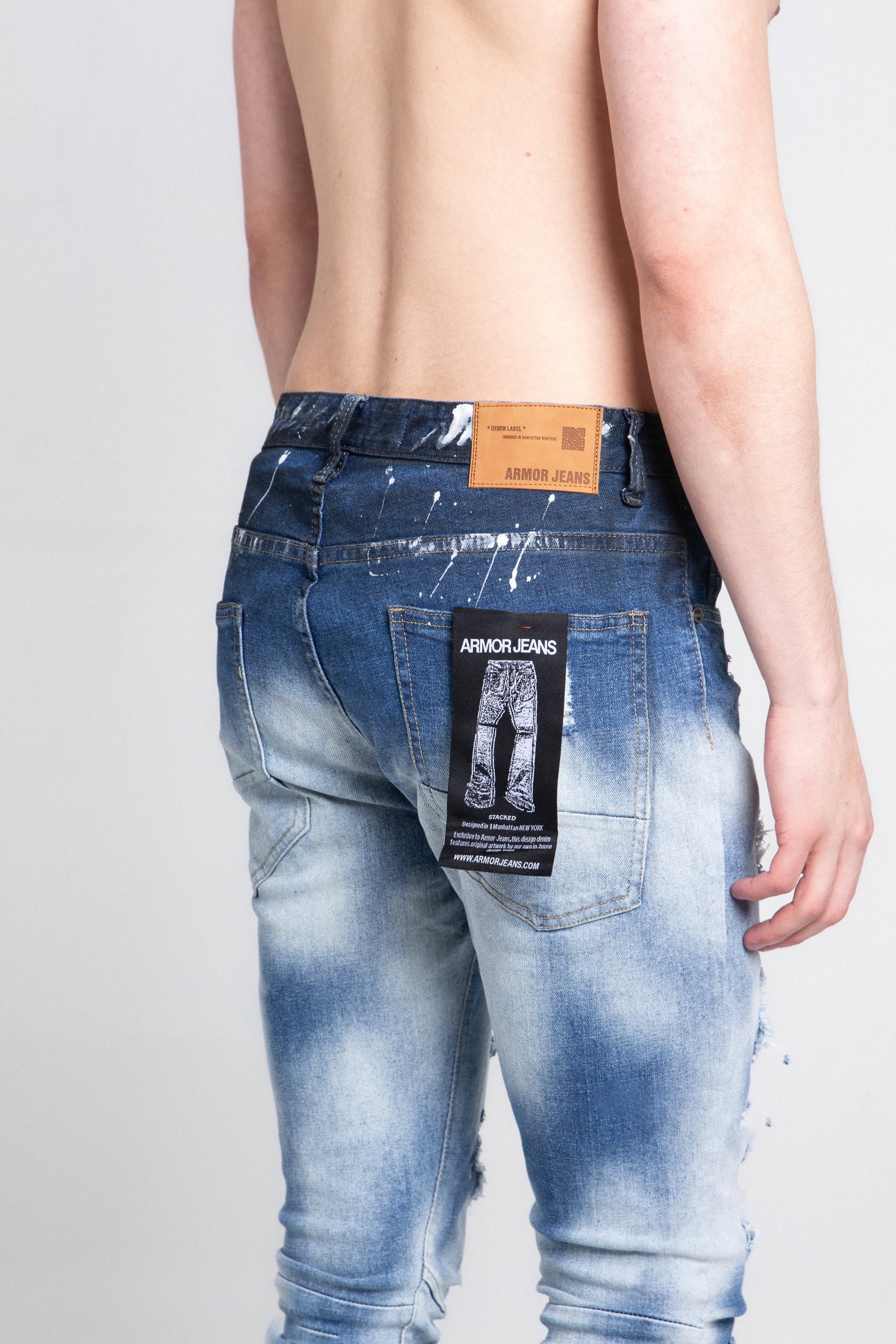 Model wearing A404 CASUAL FADED WASH SKINNY JEANS, showcasing back view with faded wash and five pocket design, mid-rise waist and stretchy fabric.