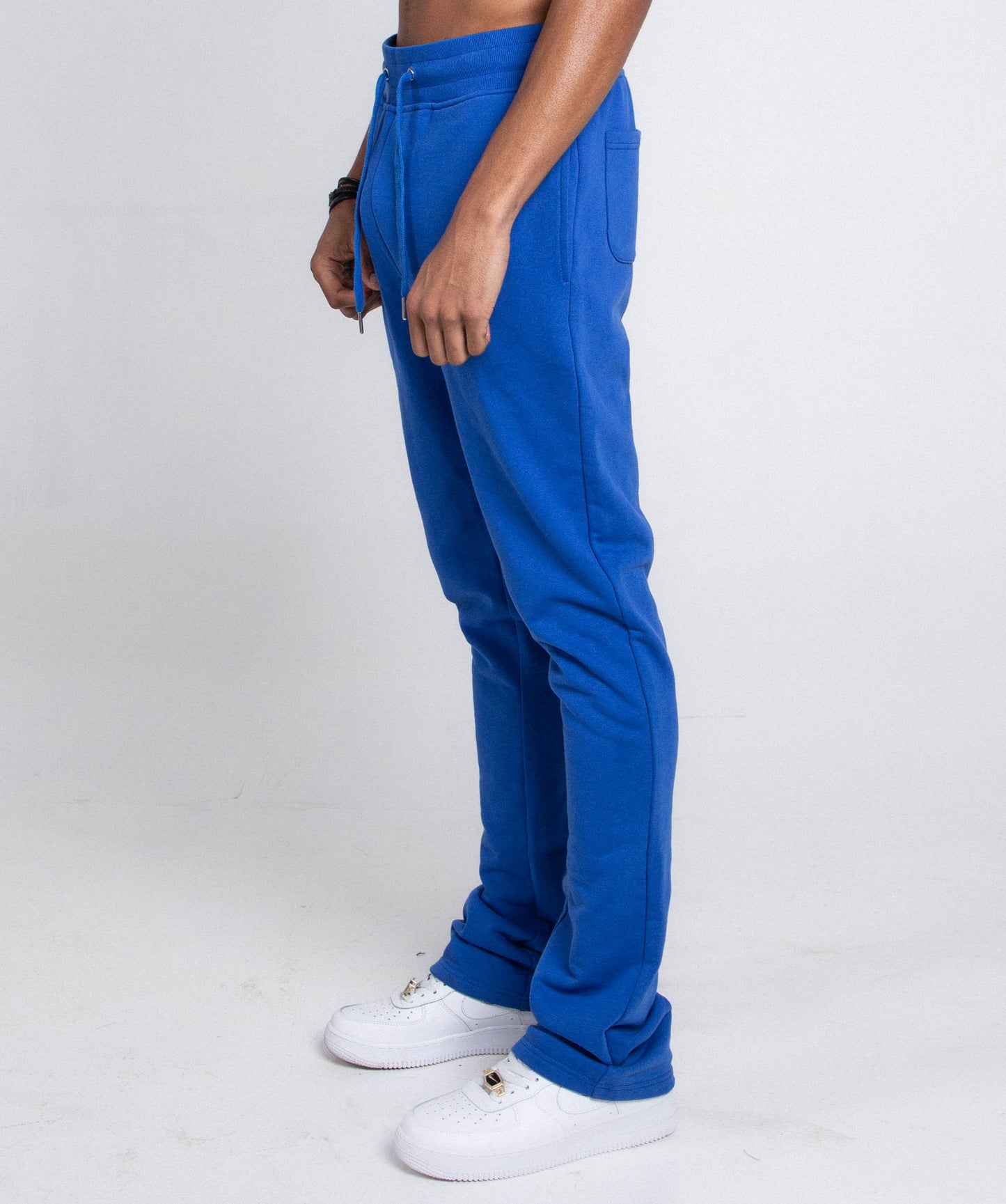 Side view of blue M5690-AJSKP MULTI-COLOR STACKED SWEATPANTS with elastic waistband and side pocket.