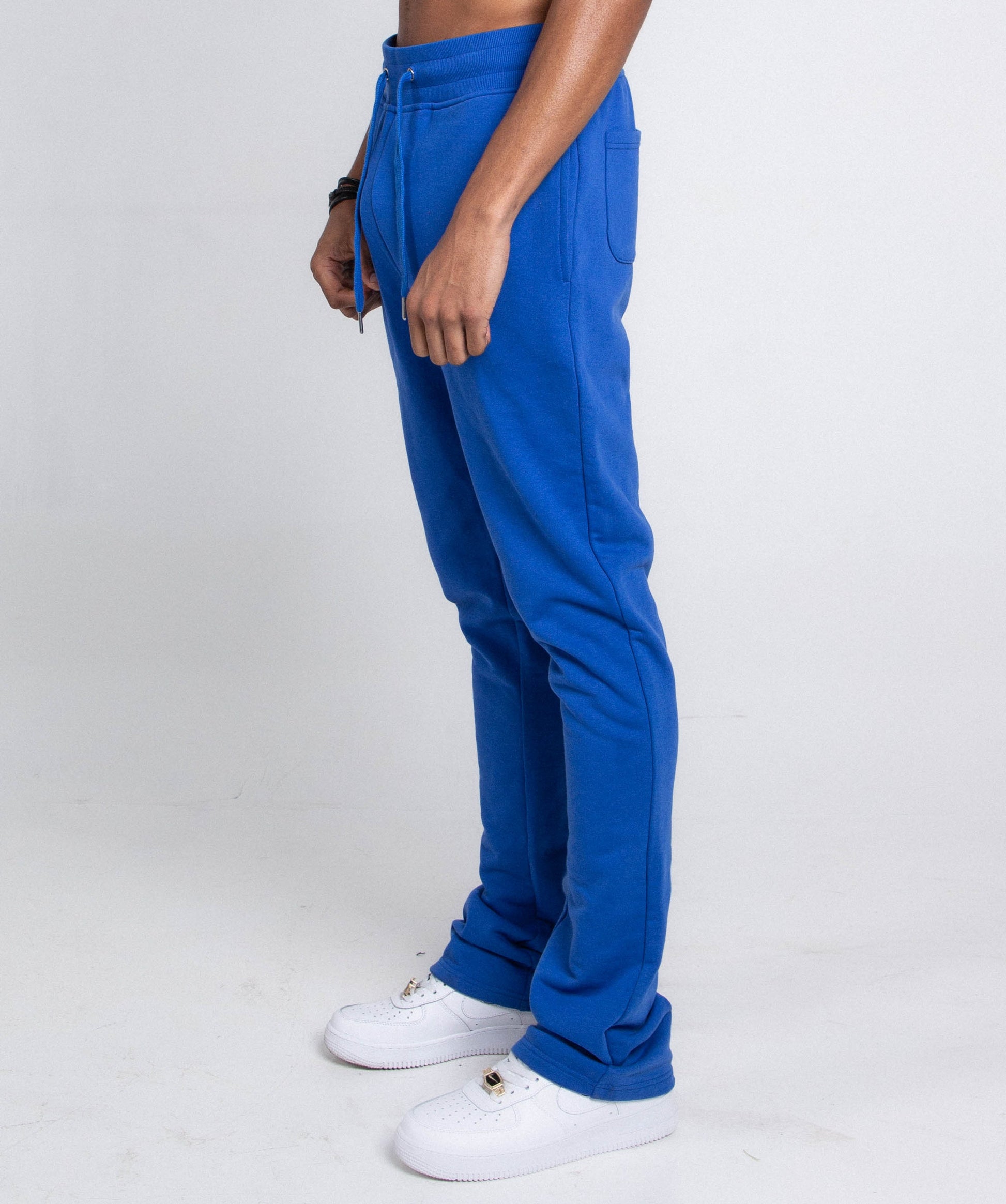 Side view of blue M5690-AJSKP MULTI-COLOR STACKED SWEATPANTS with elastic waistband and side pocket.