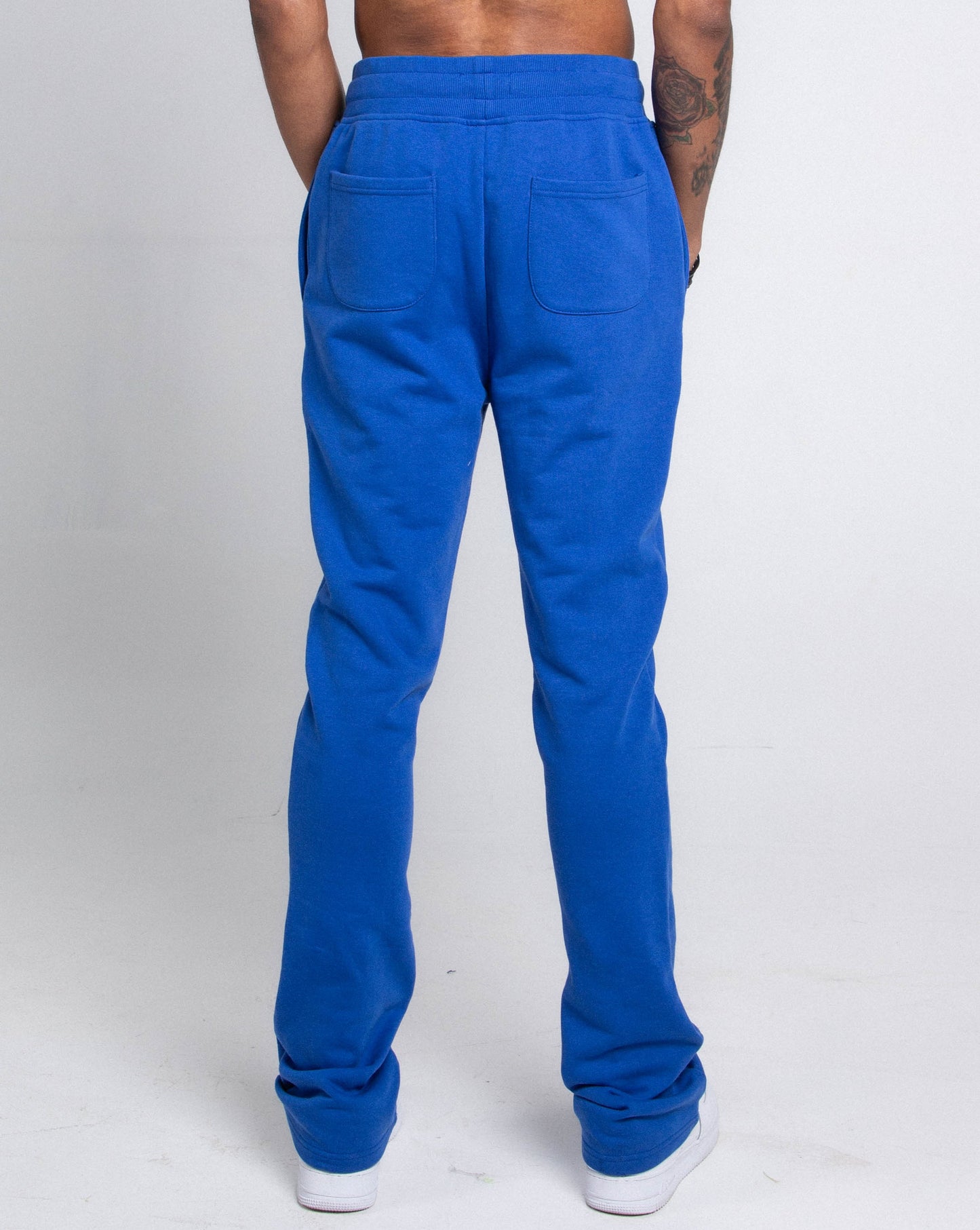 Back view of M5690-AJSKP MULTI-COLOR STACKED SWEATPANTS with elastic waistband and pockets.