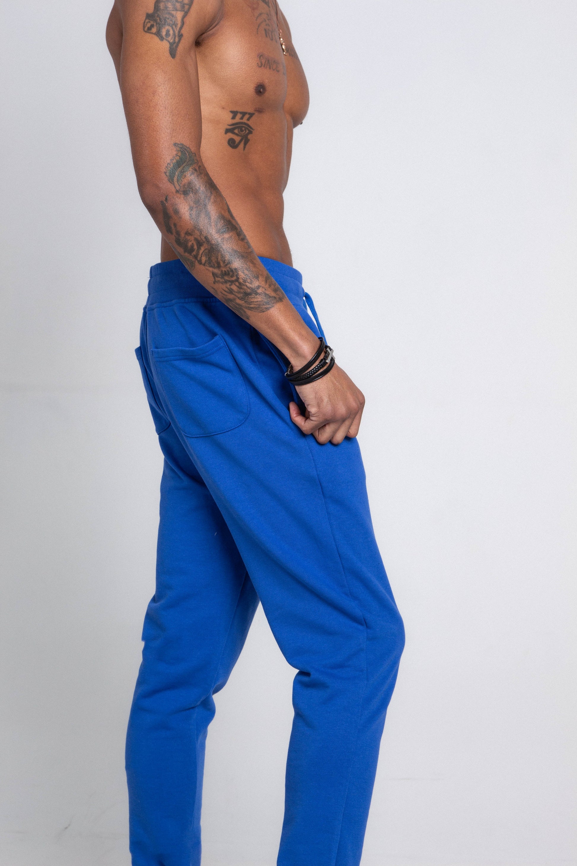 M5690-AJSKP MULTI-COLOR STACKED SWEATPANTS with elastic waistband and pockets, side view on model.