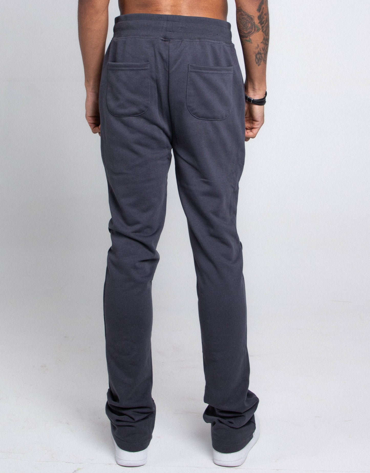 Back view of M5690-AJSKP MULTI-COLOR STACKED SWEATPANTS showing elastic waistband, drawstrings, and pockets.