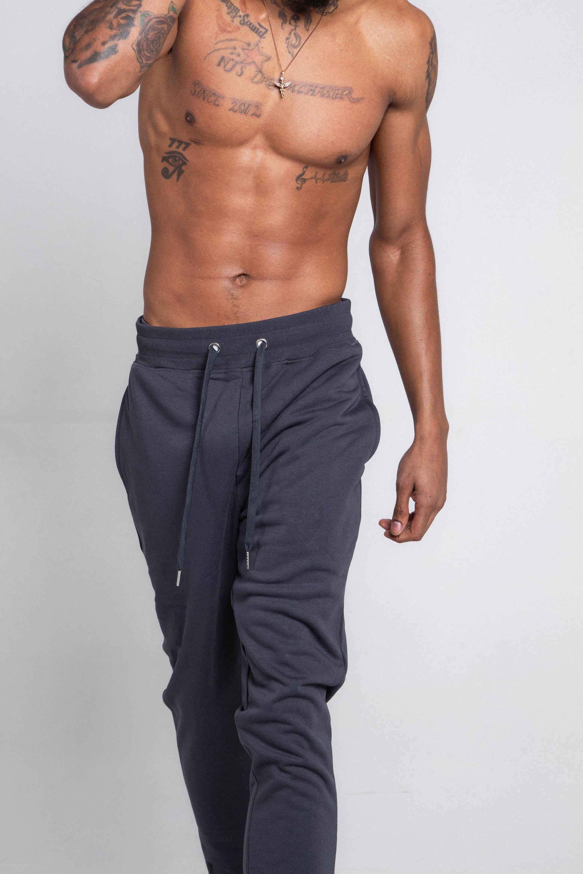 M5690-AJSKP MULTI-COLOR STACKED SWEATPANTS with elastic waistband, adjustable drawstrings, and pockets, worn by a model