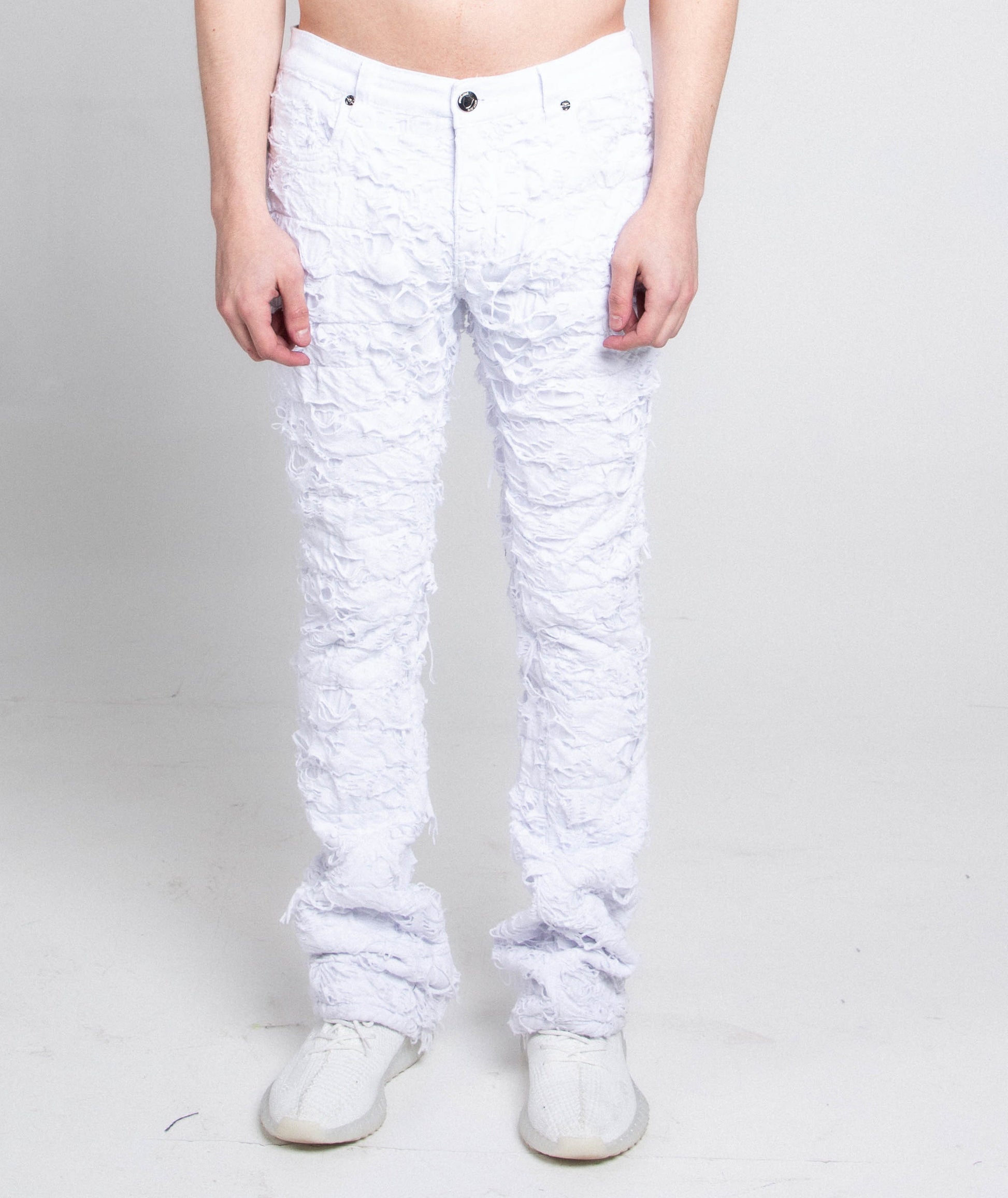 AR704 WHITE FRAYED STACKED JEANS with a mid-rise waist, stretchy fabric, and a five-pocket design shown front view on model.