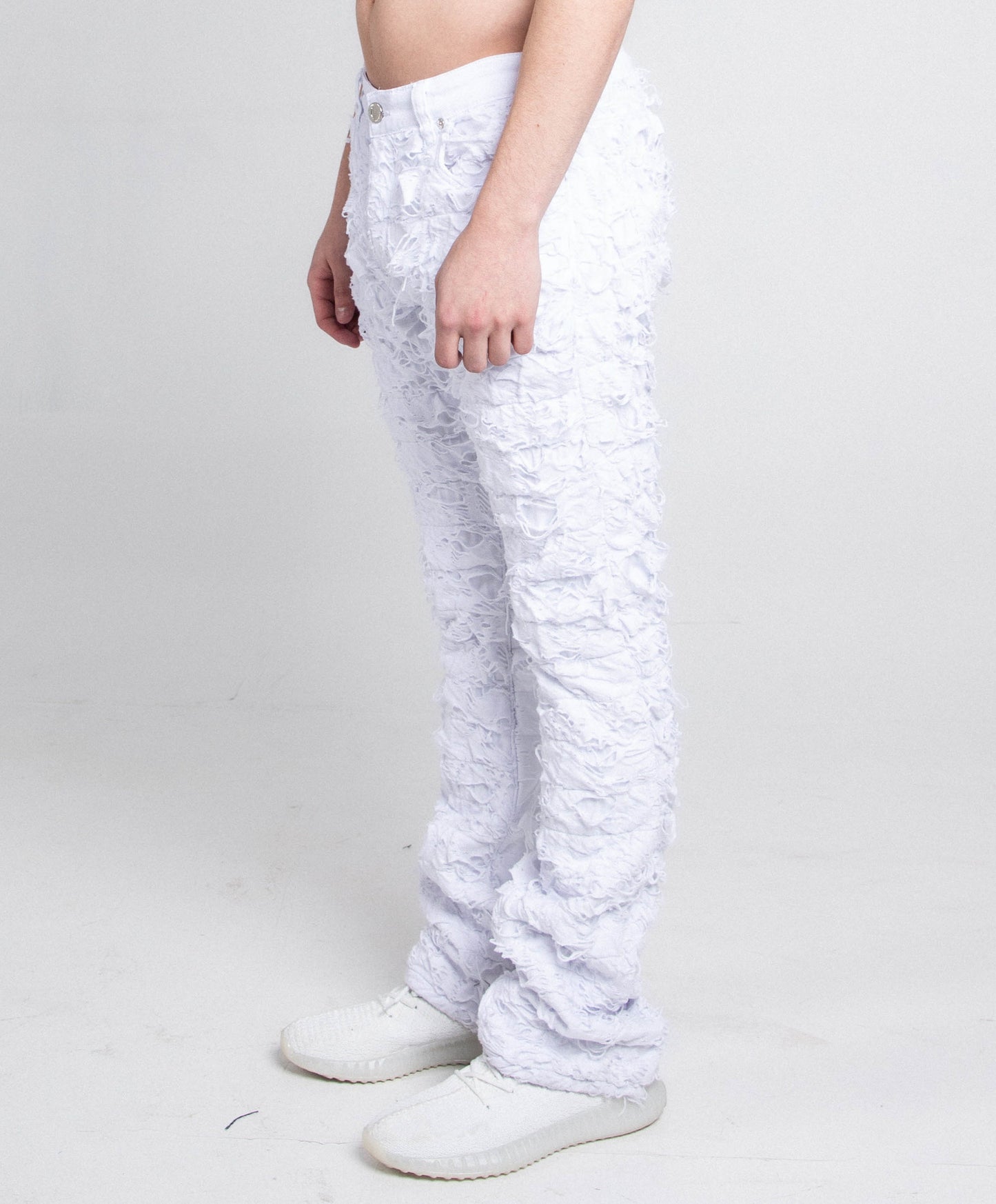 AR704 WHITE FRAYED STACKED JEANS with mid-rise waist and stretchy fabric, featuring a ripped design and five-pocket style.