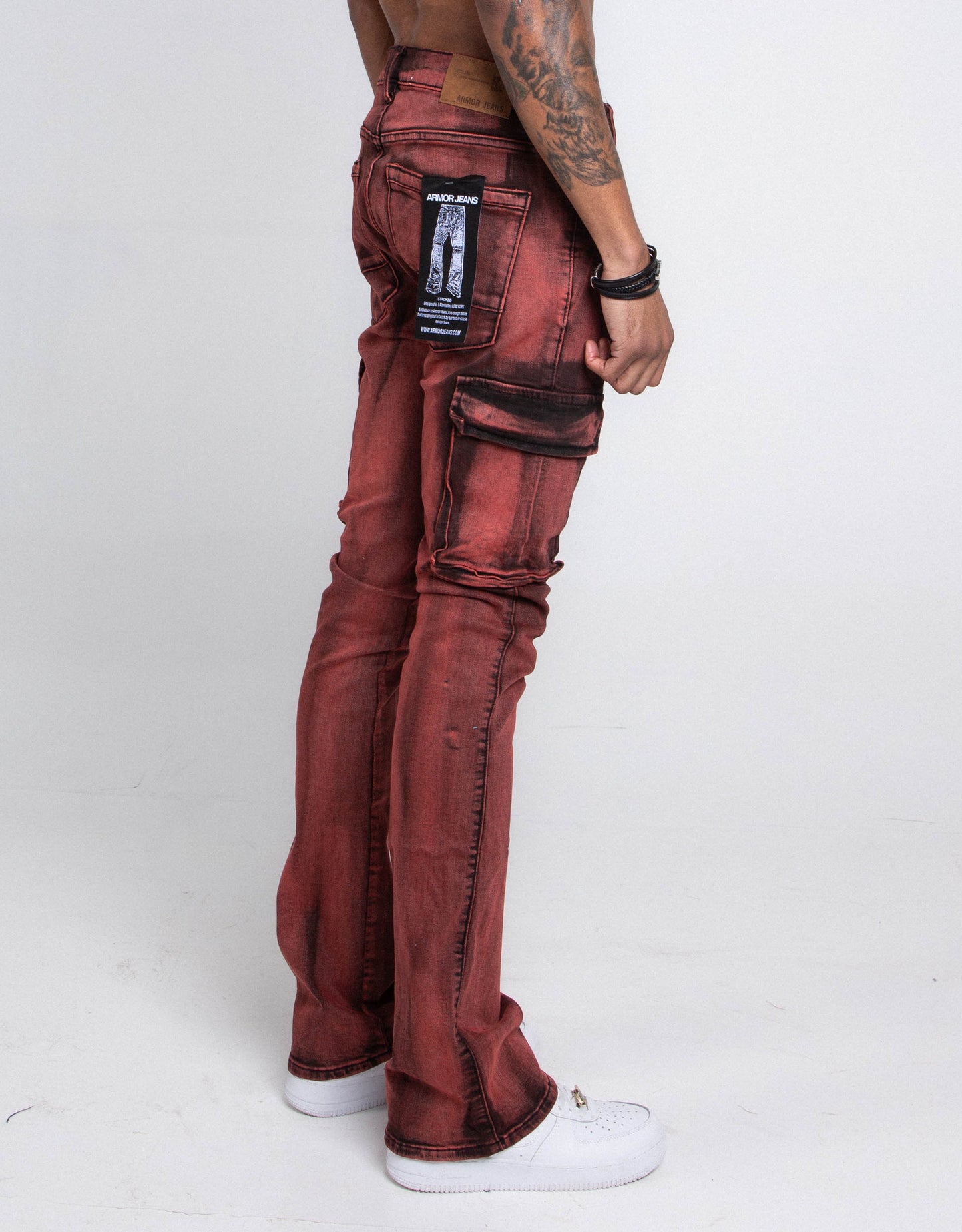 Side view of red stacked cargo jeans with cargo pocket and zipper fly design.