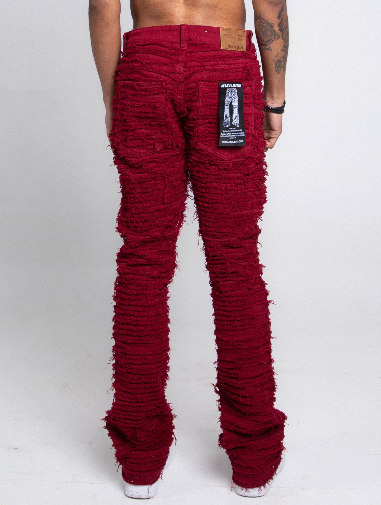 Back view of AJS693 EXTREME FRAYED STACKED JEANS in red with mid-rise waist, stretchy fabric, and extreme frayed design.