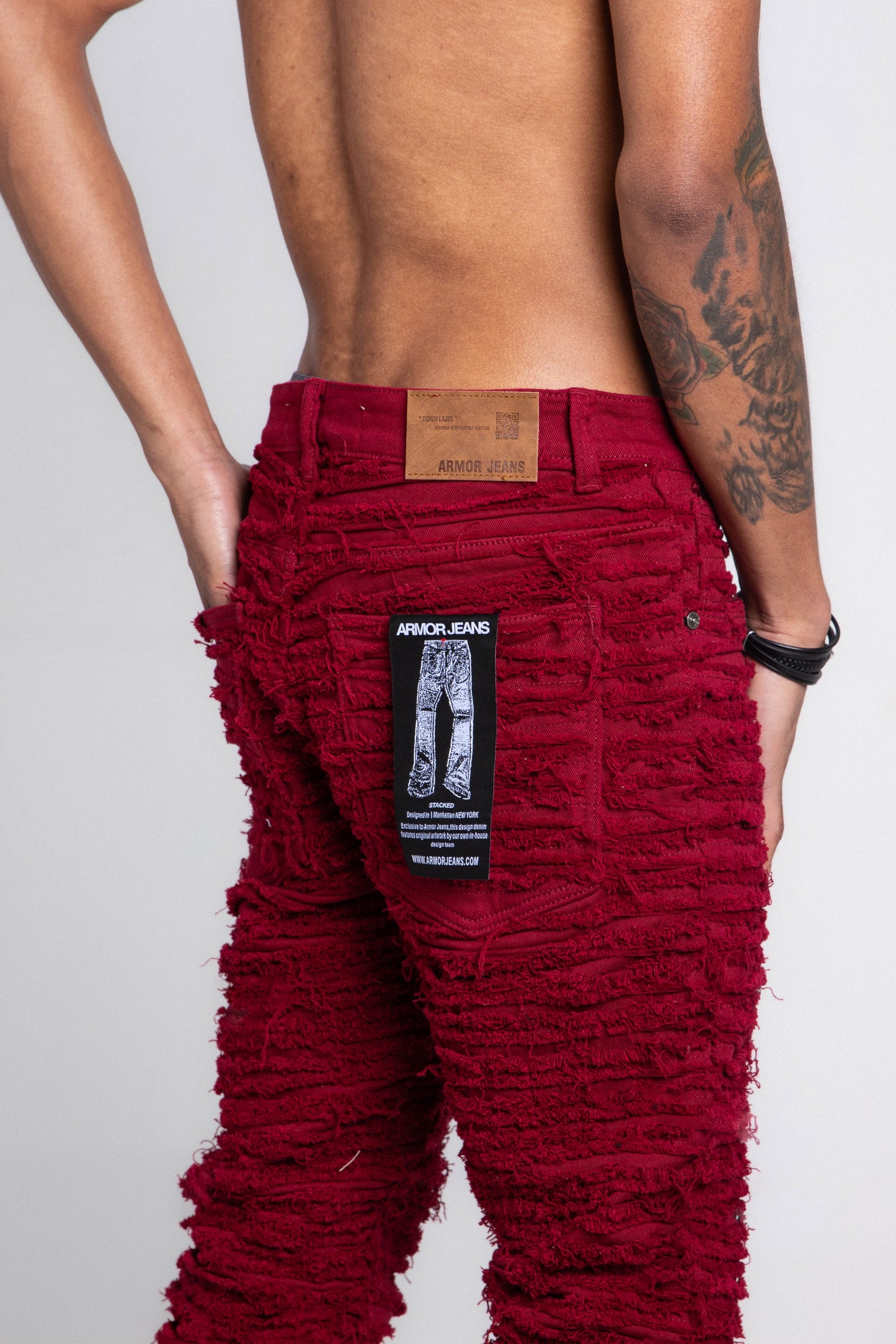 AJS693 EXTREME FRAYED STACKED JEANS in red showing back view with frayed design and label detail