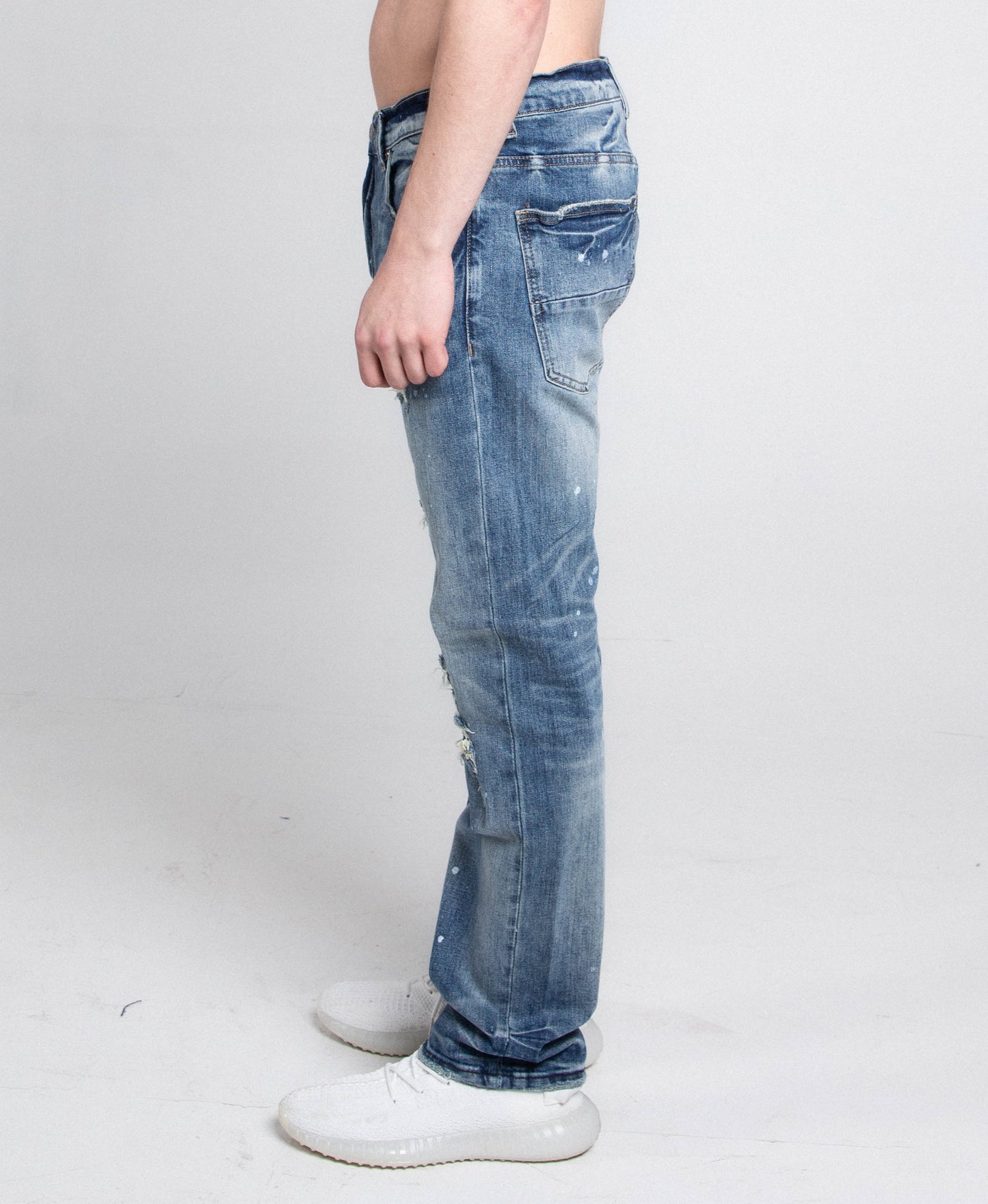 Side view of AJ05C CASUAL SKINNY DISTRESSED JEANS with mid-rise waist, stretchy fabric, featuring five pockets and zipper fly.