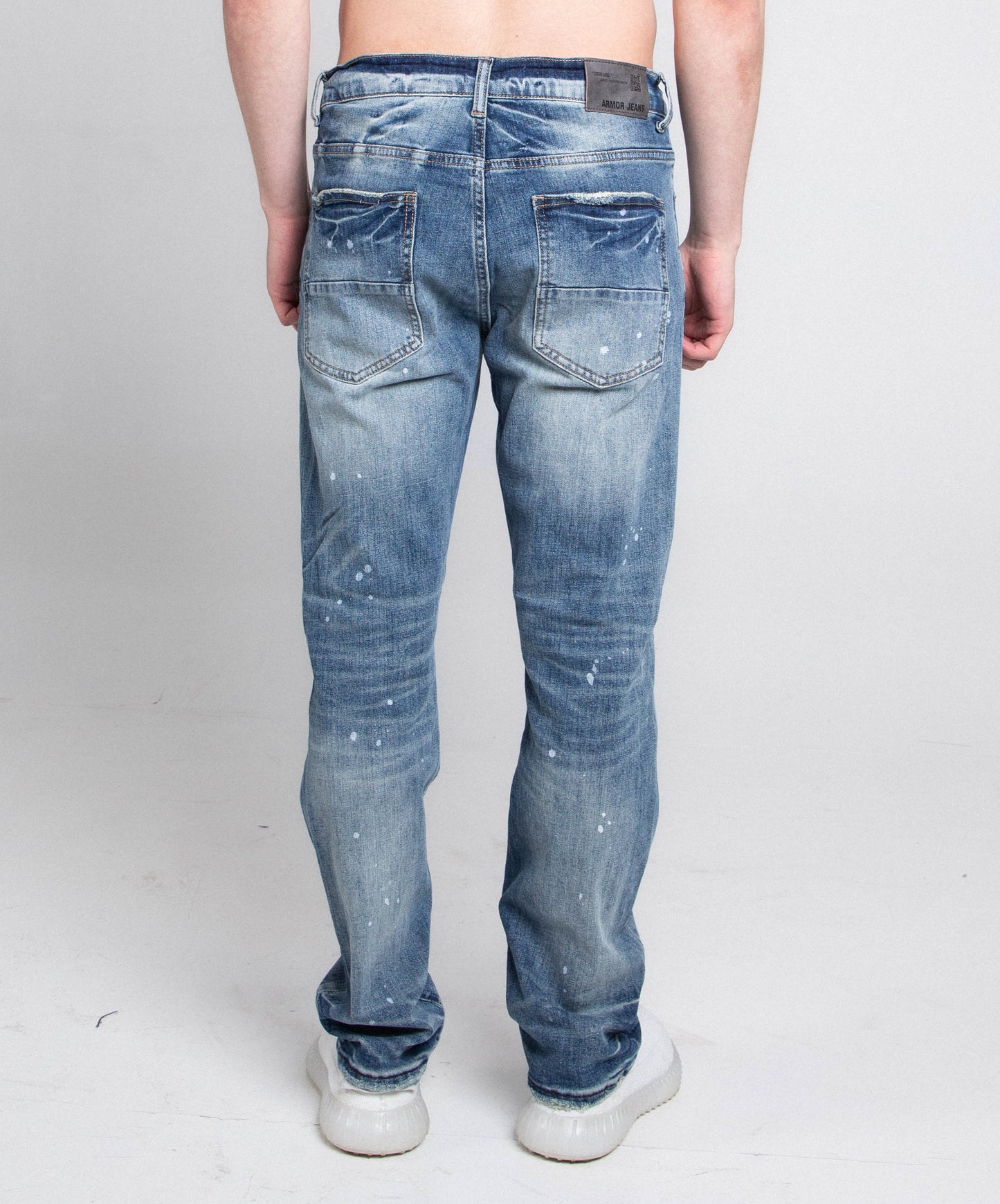 Back view of AJ05C CASUAL SKINNY DISTRESSED JEANS showing mid-rise waist and stretchy skinny leg in blue denim.