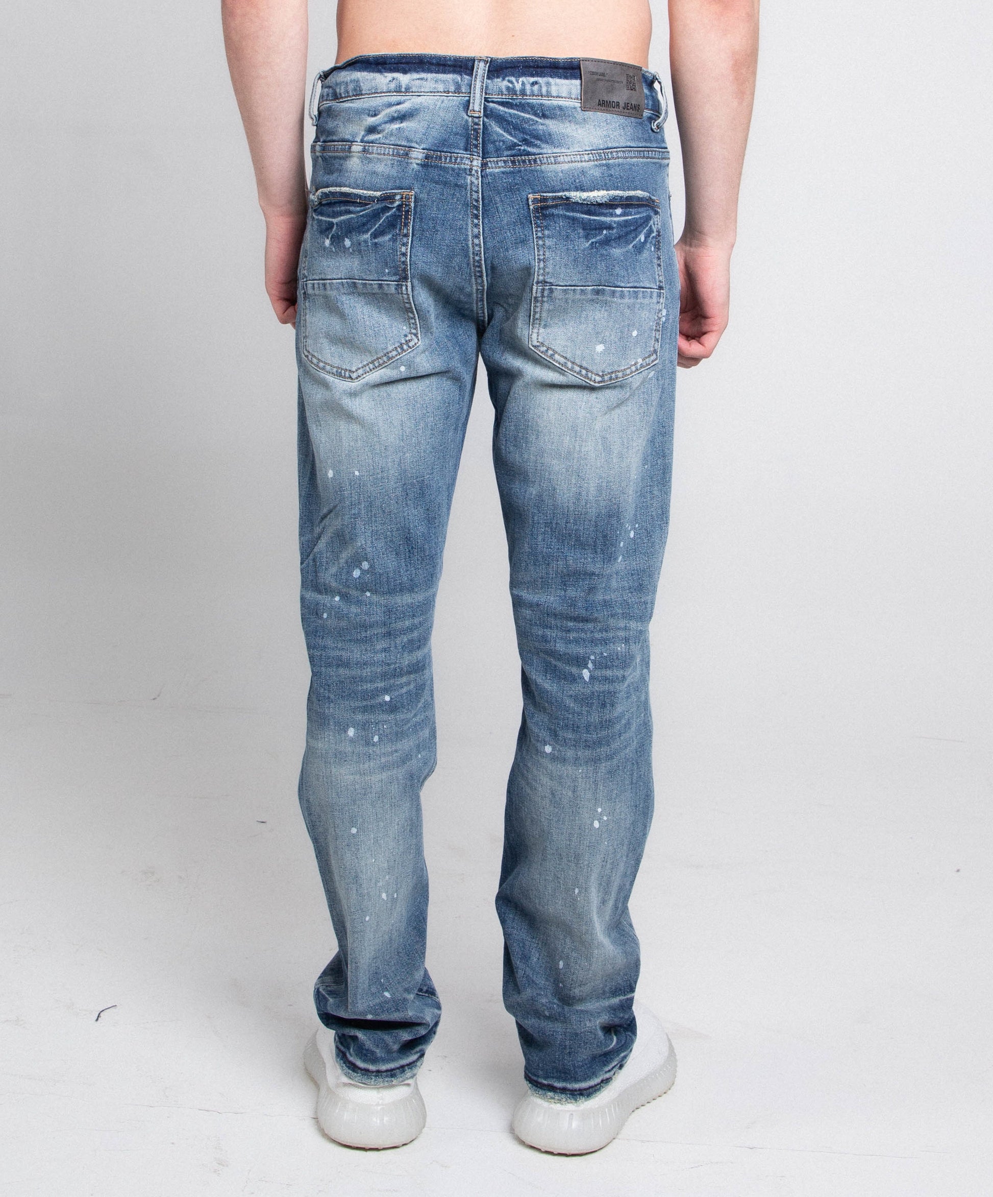 Back view of AJ05C CASUAL SKINNY DISTRESSED JEANS showing mid-rise waist and stretchy skinny leg in blue denim.