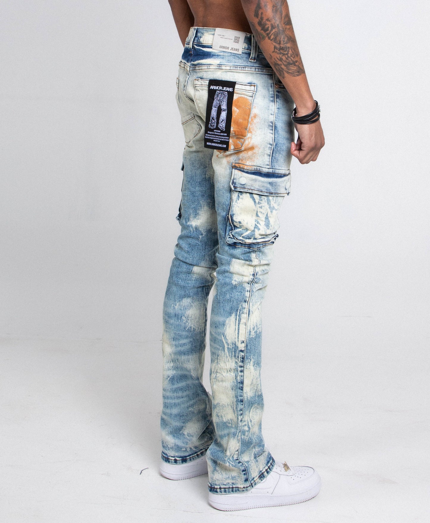 Side view of AJ29SK GREY/WHITE WASH STACKED CARGO JEANS with splash paint design, cargo pockets, and mid-rise waist.