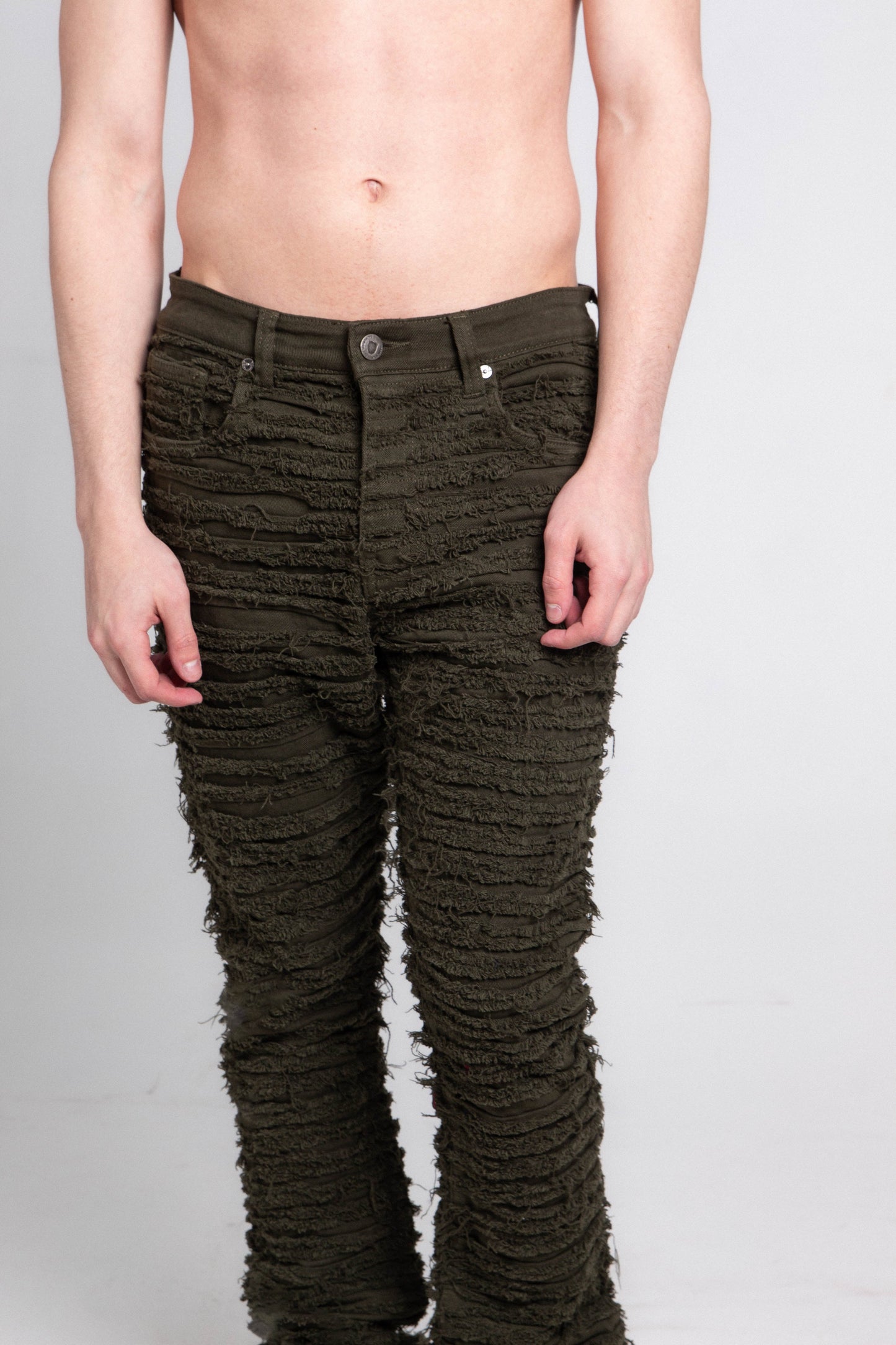 Model wearing AJS693 EXTREME FRAYED STACKED JEANS with mid rise and stretchy cotton fabric featuring a five-pocket design