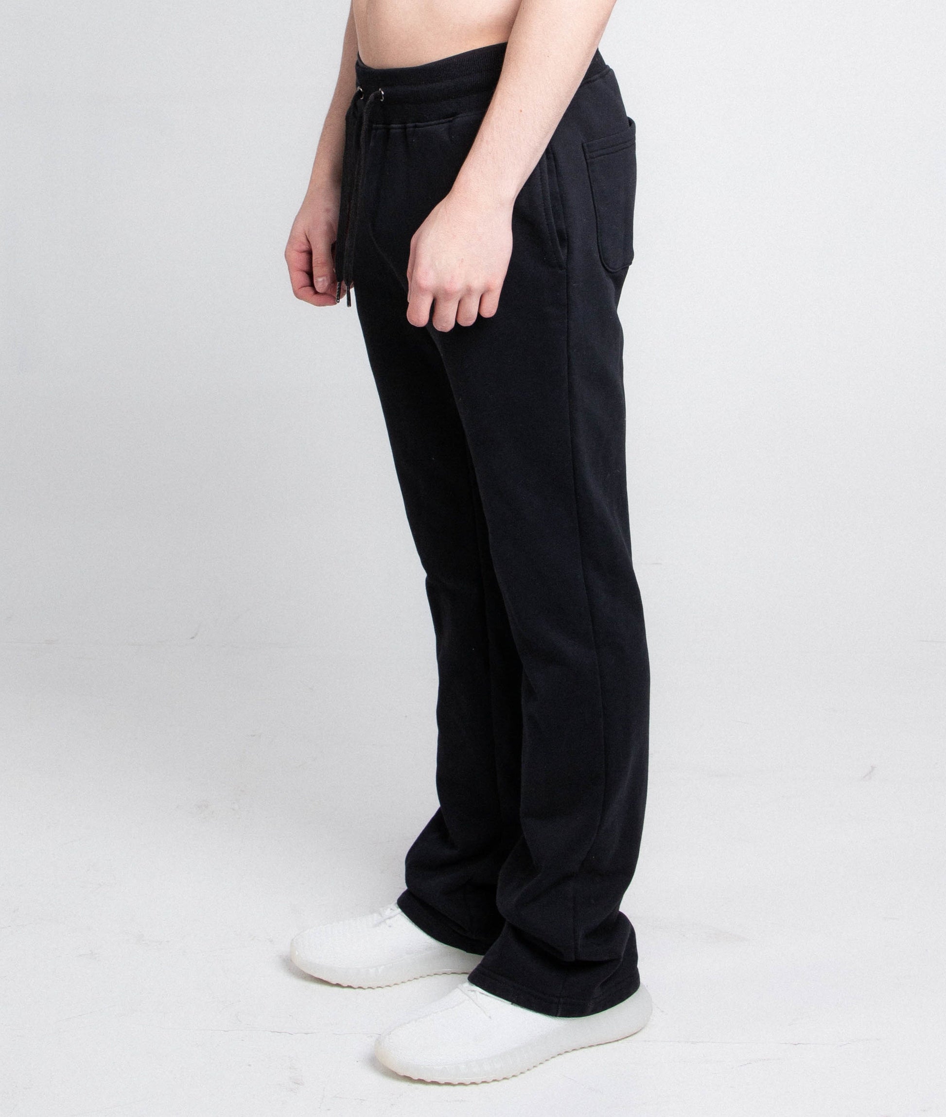 Side view of person wearing black M5690-AJSKP multi-color stacked sweatpants with elastic waistband and drawstrings.