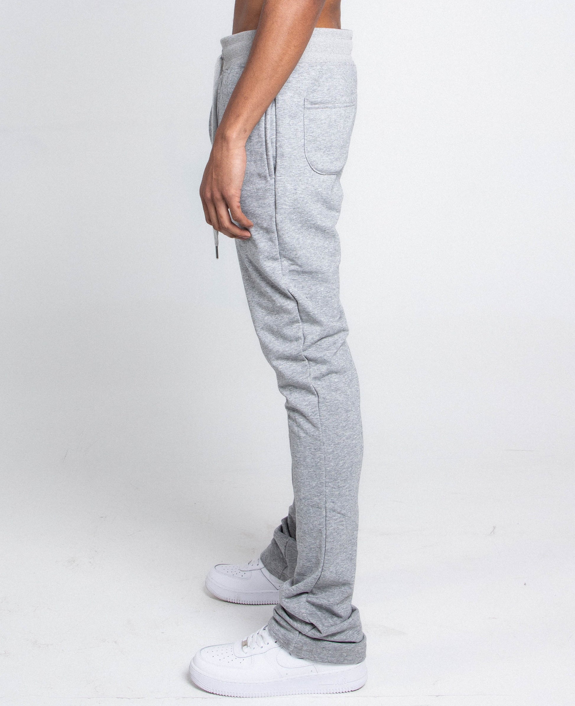 Side view of M5690-AJSKP MULTI-COLOR STACKED SWEATPANTS with elastic waistband and drawstrings, side pocket visible.