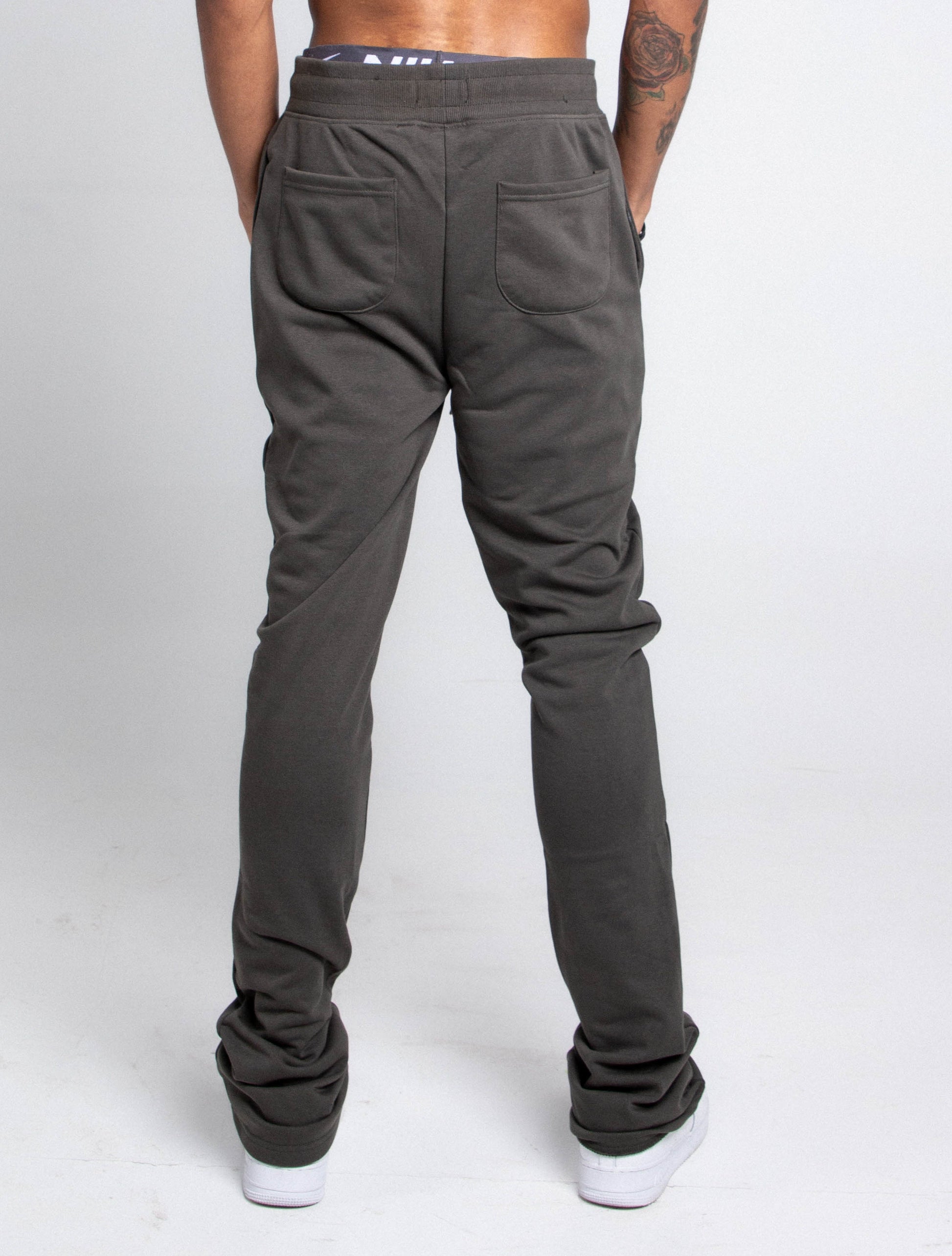 Back view of M5690-AJSKP MULTI-COLOR STACKED SWEATPANTS with elastic waistband and pockets.