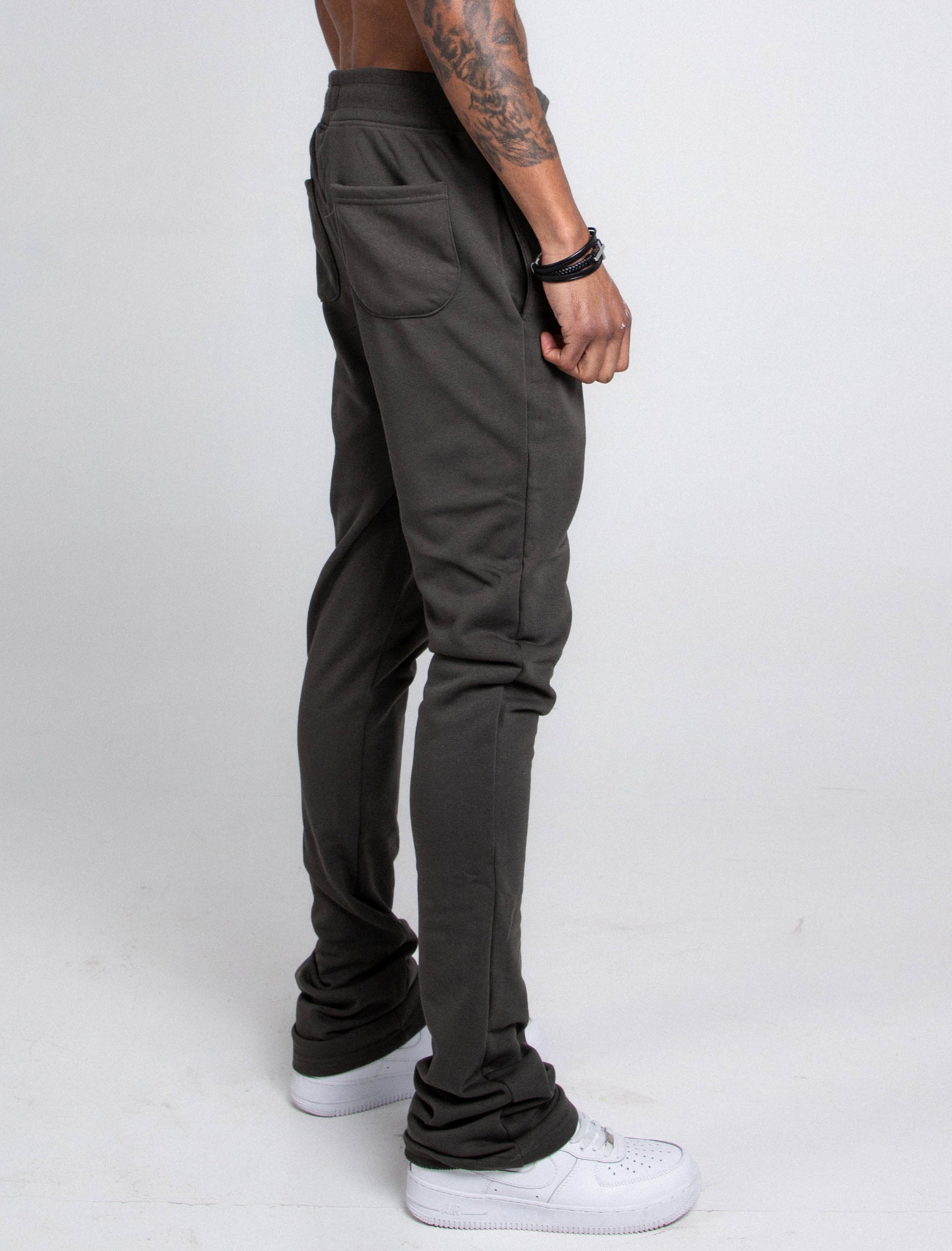 Side view of M5690-AJSKP MULTI-COLOR STACKED SWEATPANTS with elastic waistband, drawstrings, pockets, worn by model.